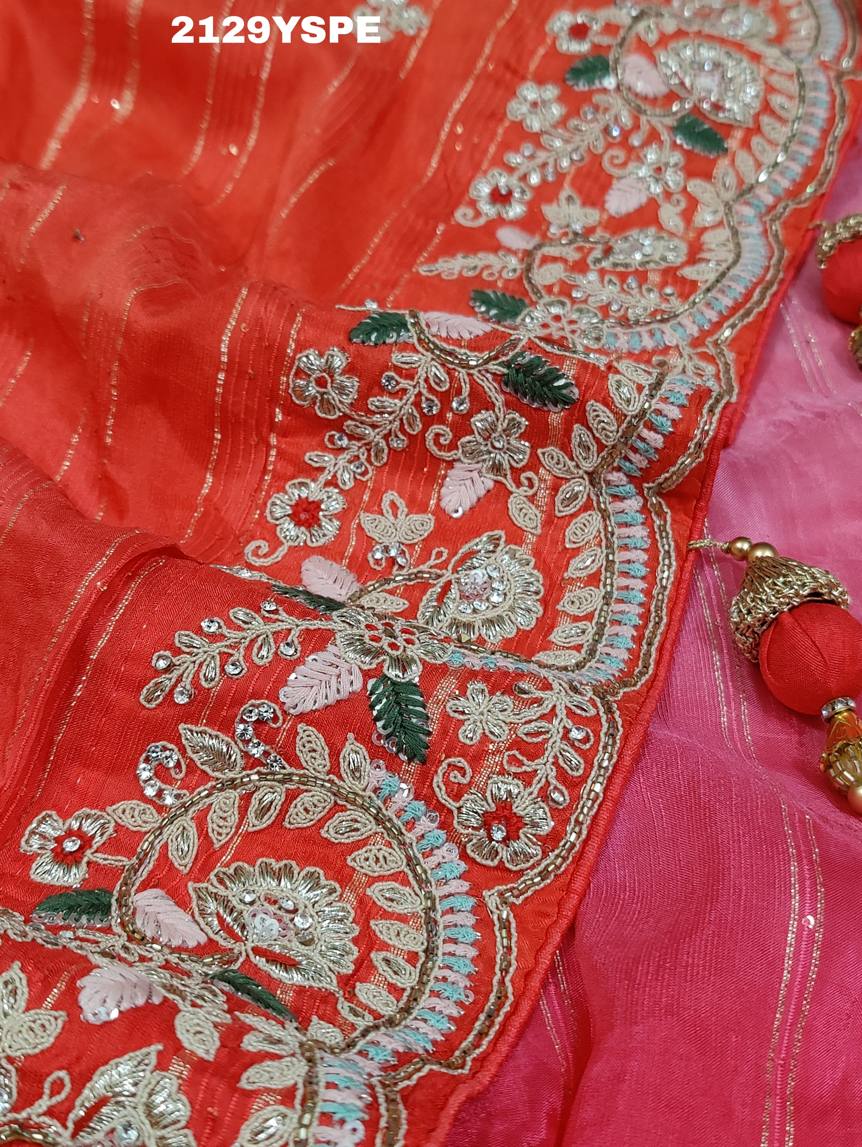 red saree with golden and silver embellishments and cutdana work, showcasing a traditional and festive design.