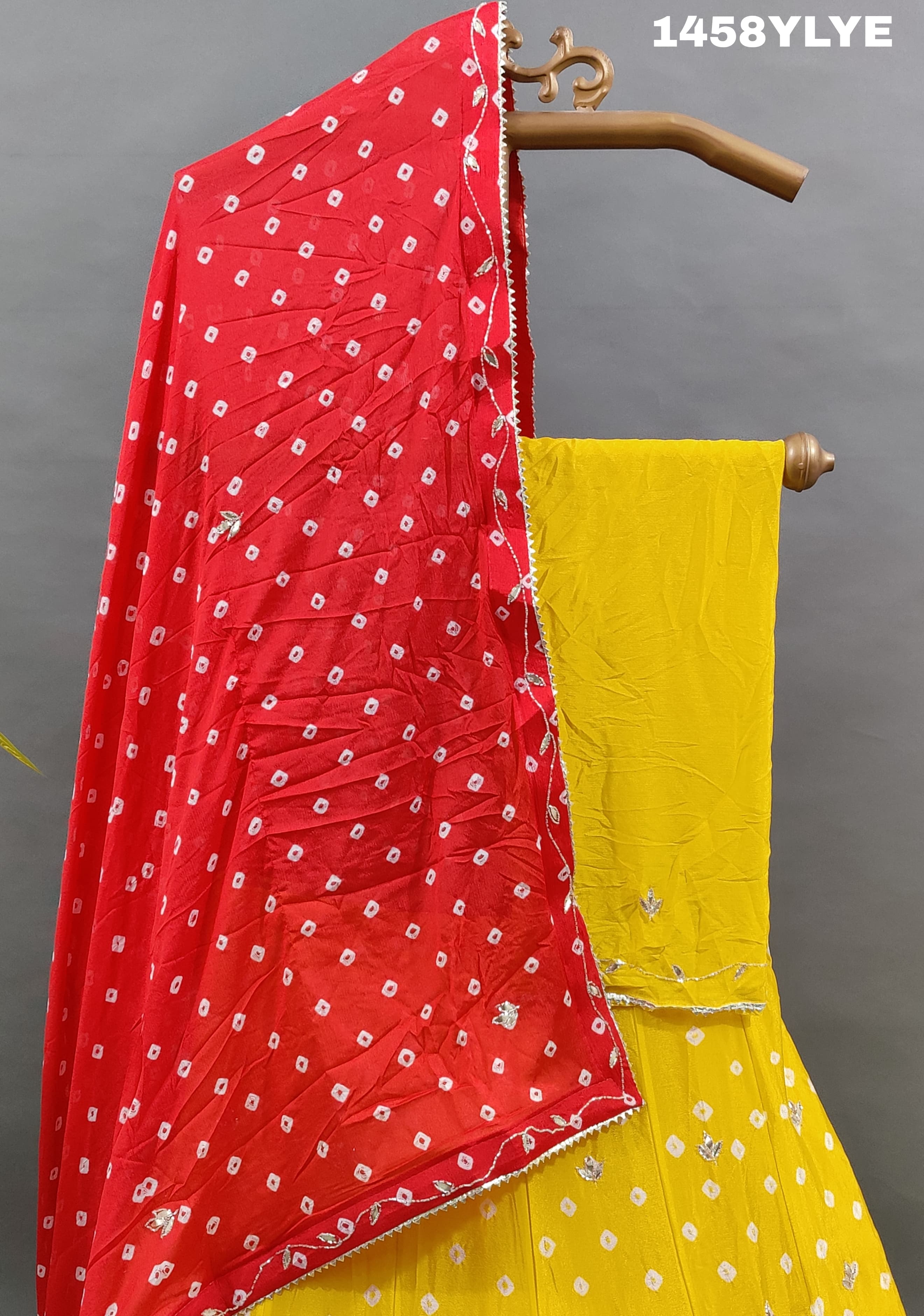 A traditional yellow lehenga with red bandhani style