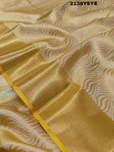 A yellow and gold tissue silk saree with Banarasi zari border