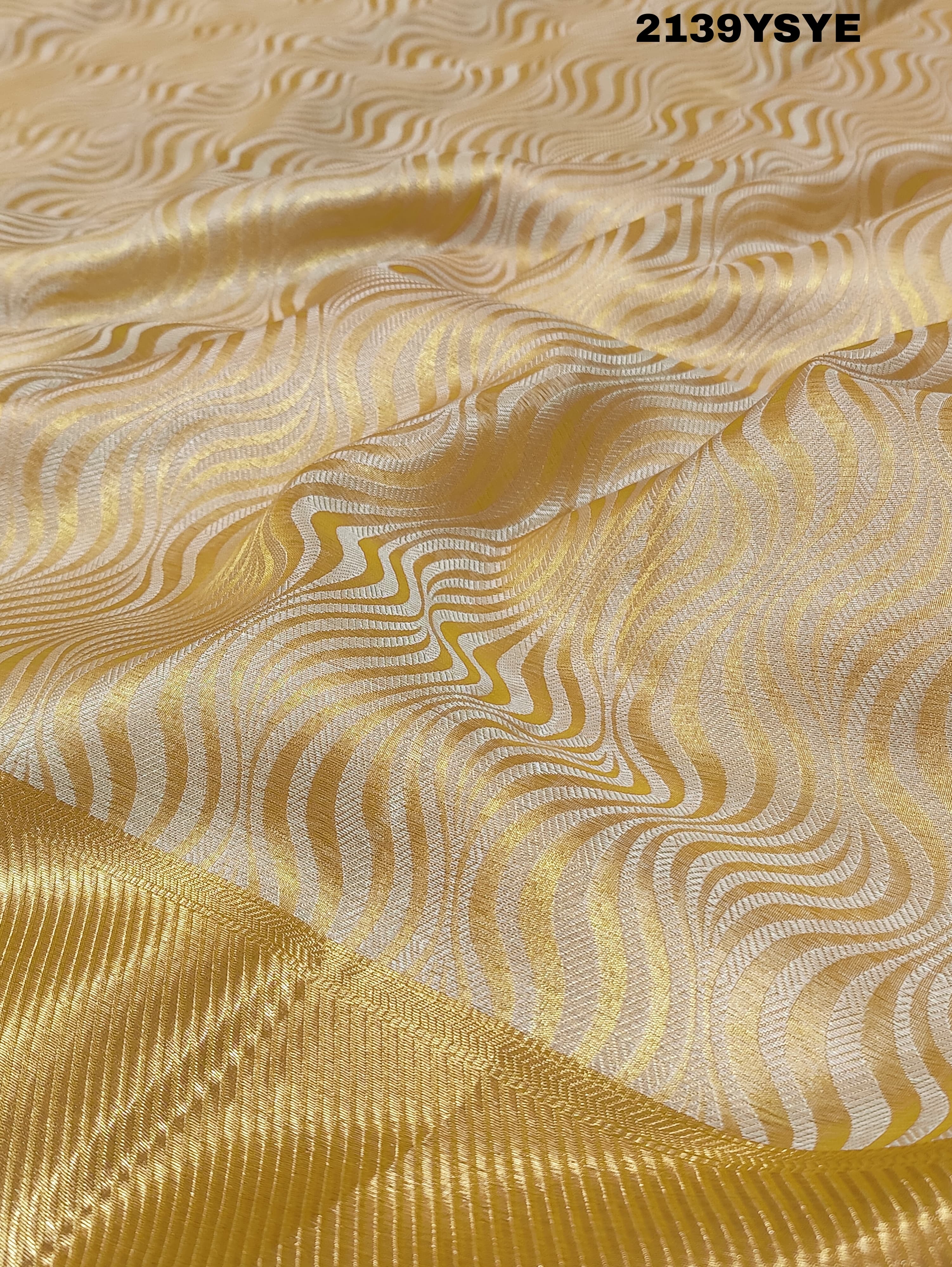 A yellow and gold tissue silk saree with Banarasi zari border
