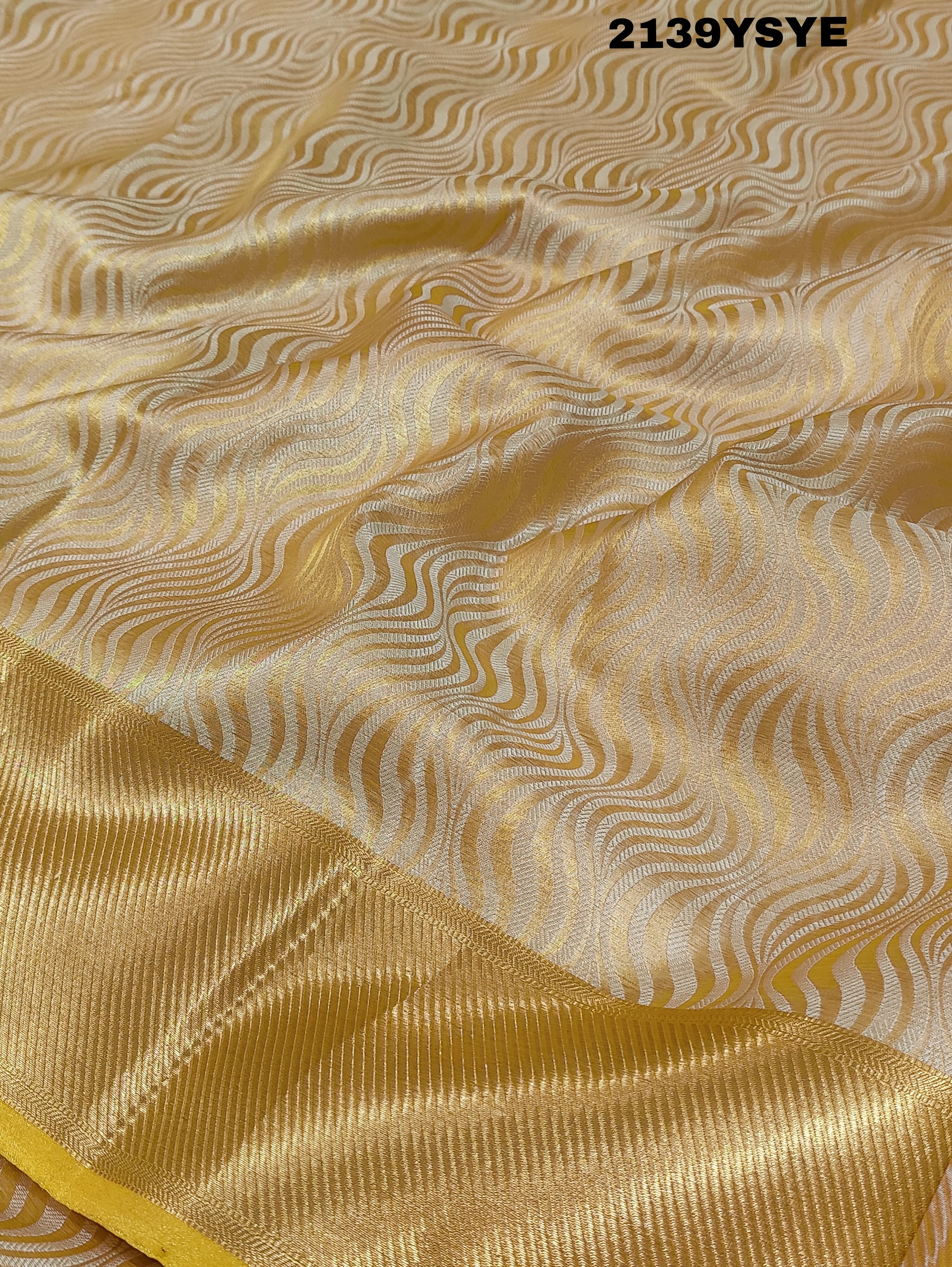 A yellow and gold tissue silk saree with Banarasi zari border