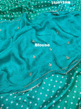 A green saree with bandhani pattern and cutdana work