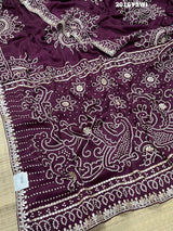A purple saree with detailed gold Gota patti work