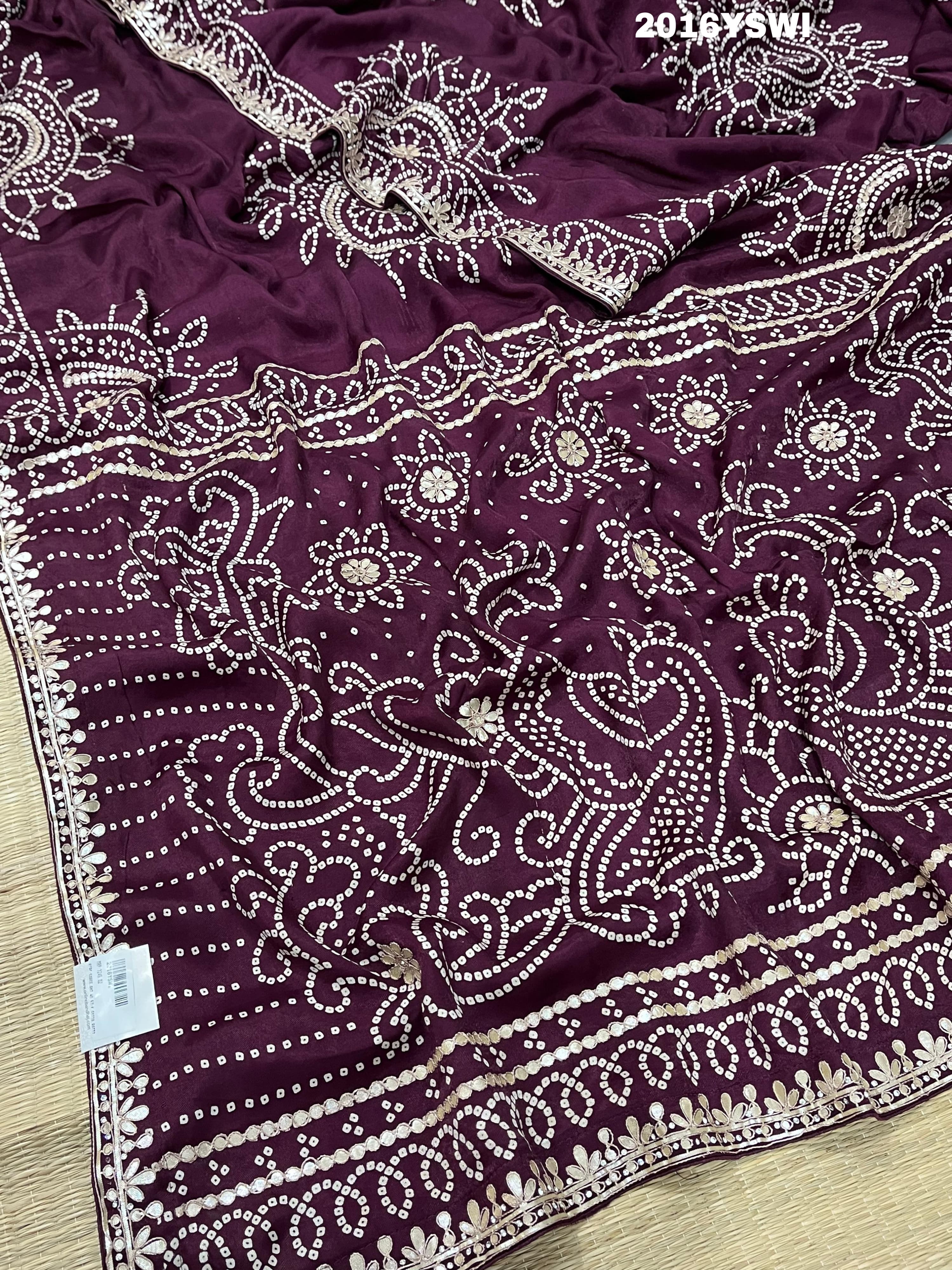 A purple saree with detailed gold Gota patti work