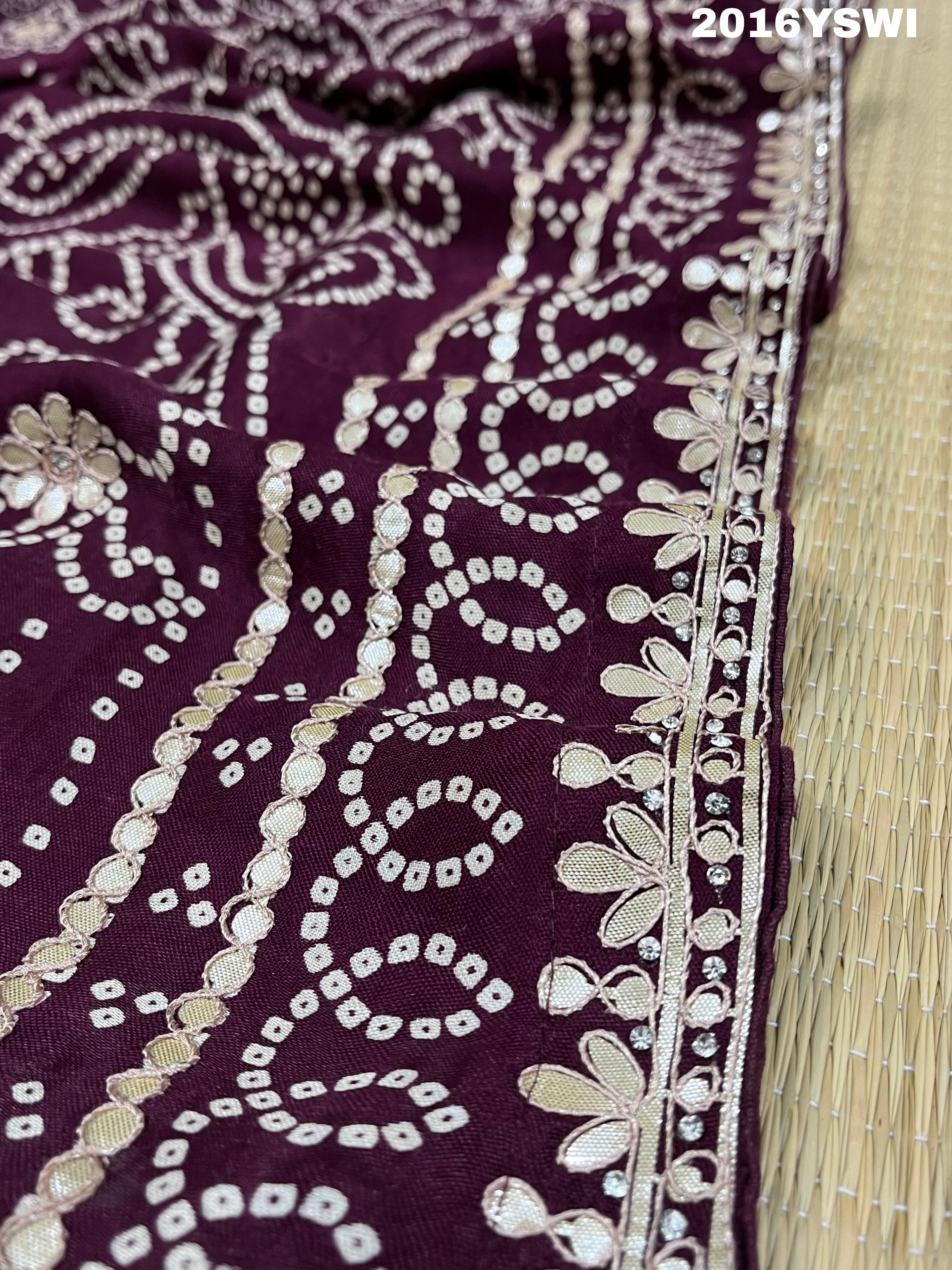 A purple saree with detailed gold Gota patti work