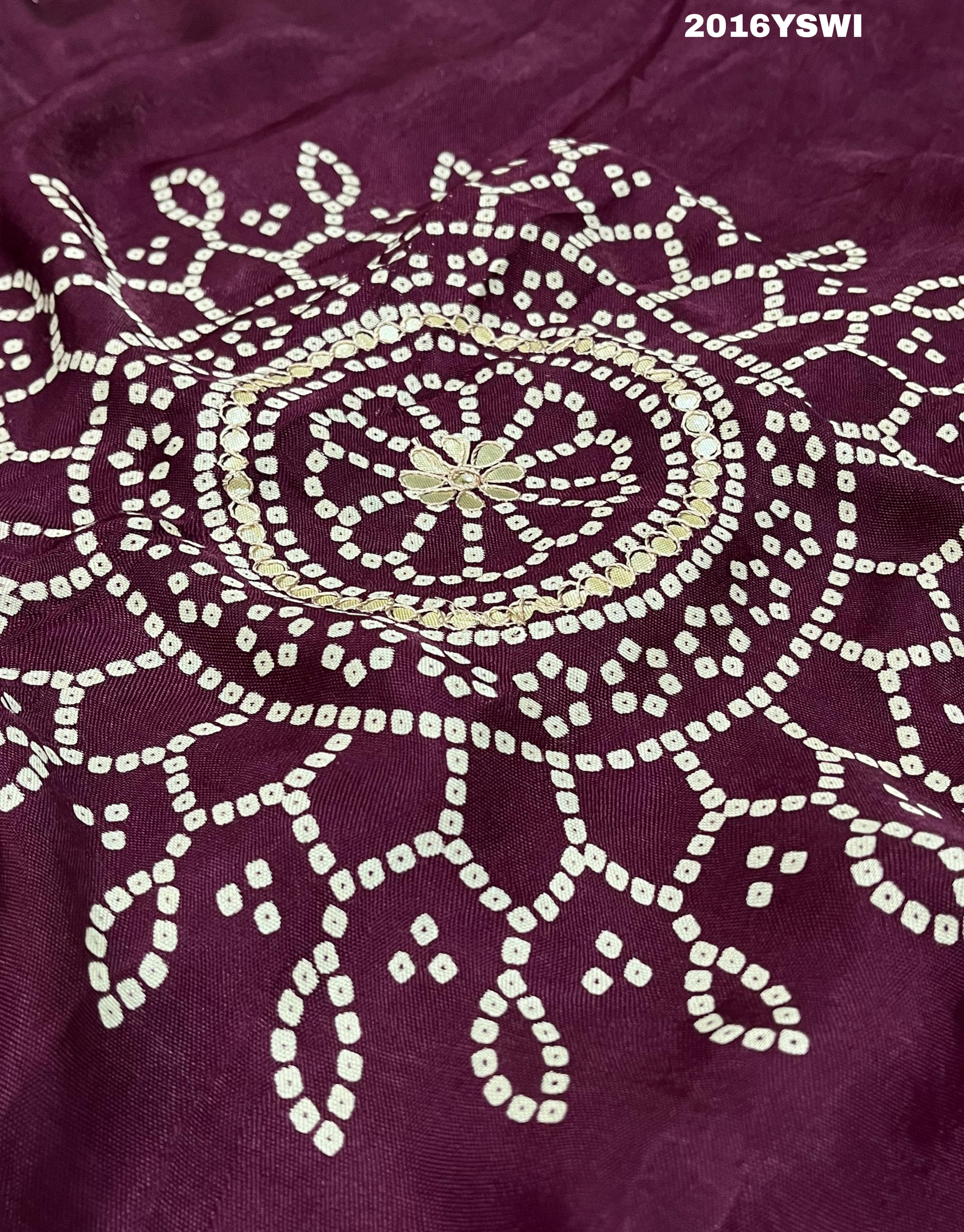 A purple saree with detailed gold Gota patti work