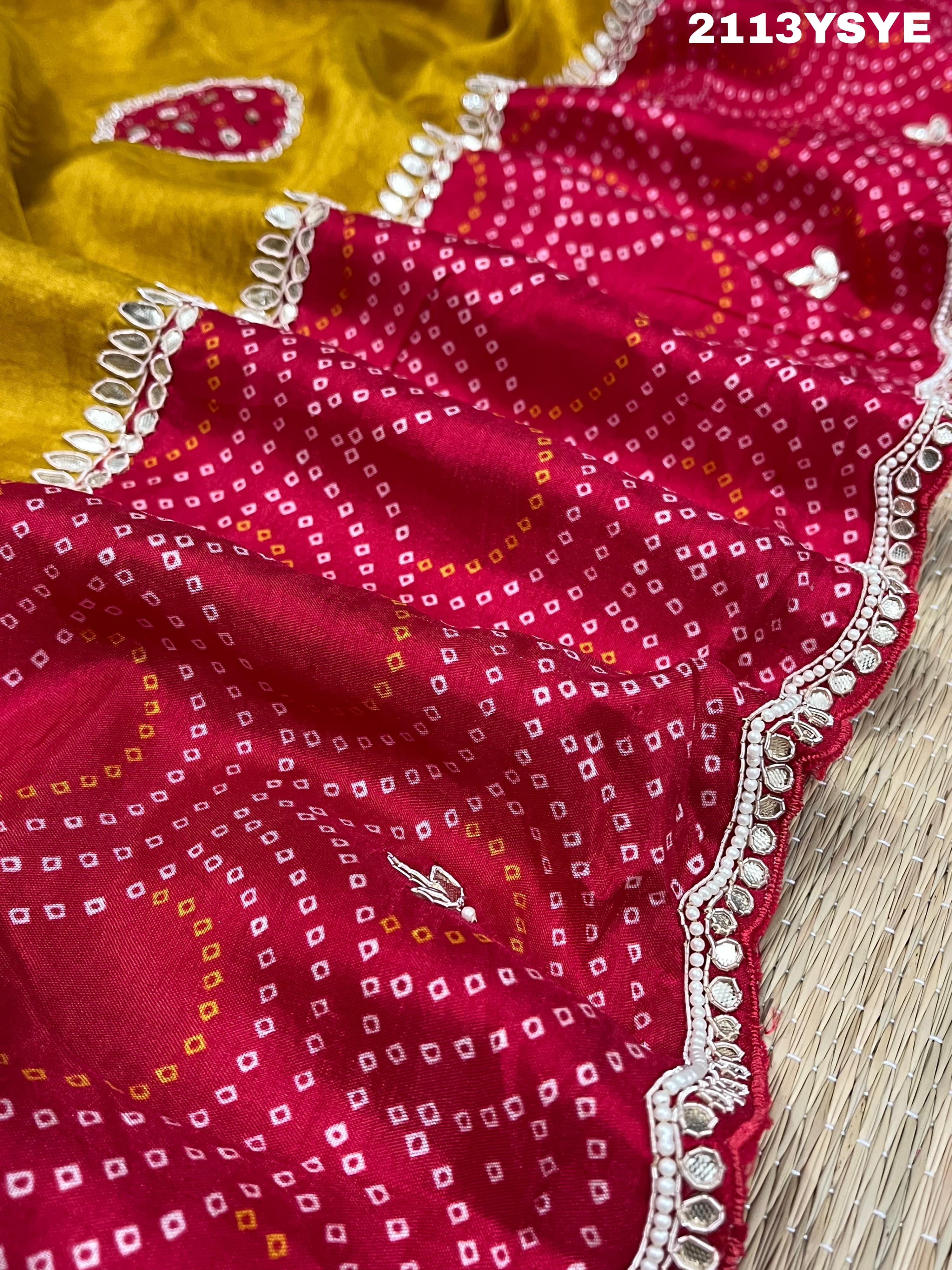 A yellow and red bandhani style dola silk saree with gota patti work