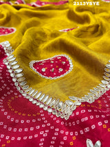 A yellow and red bandhani style dola silk saree with gota patti work