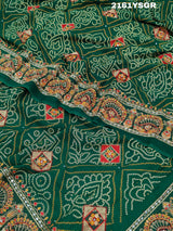 A green saree with red bandhej patterns and royal aari work, along with real mirror work on the border.