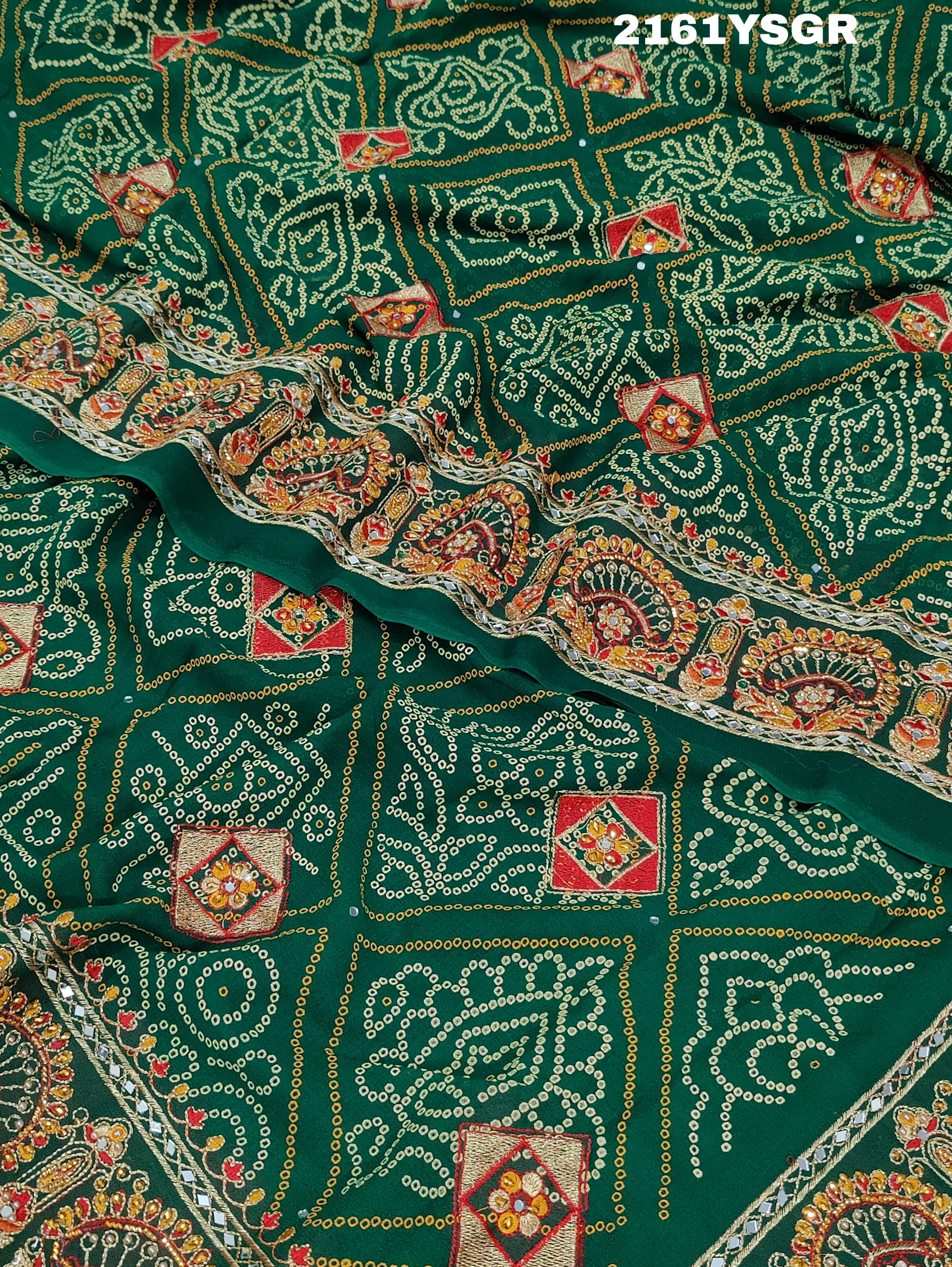 A green saree with red bandhej patterns and royal aari work, along with real mirror work on the border.