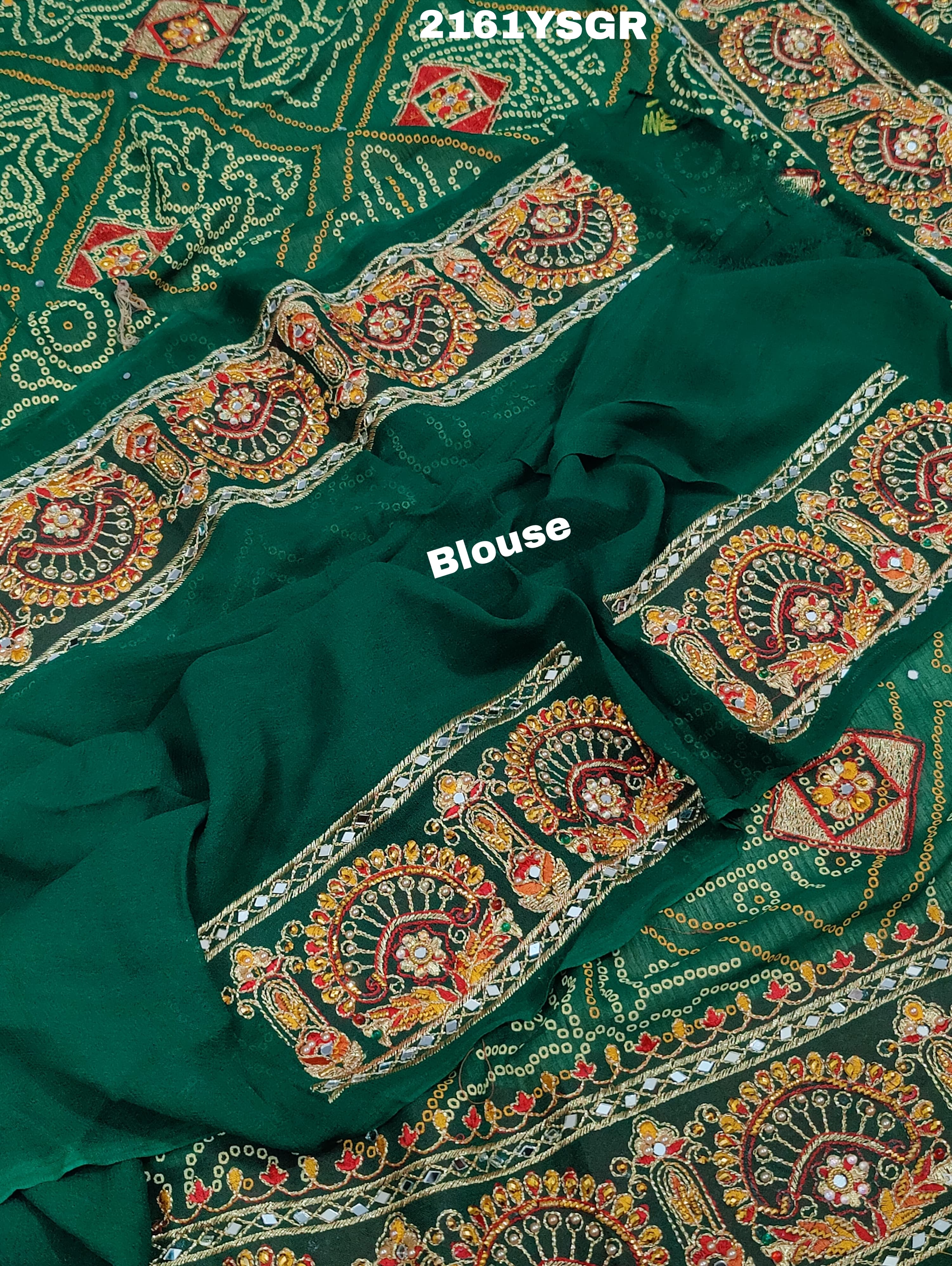 A green saree with red bandhej patterns and royal aari work, along with real mirror work on the border.
