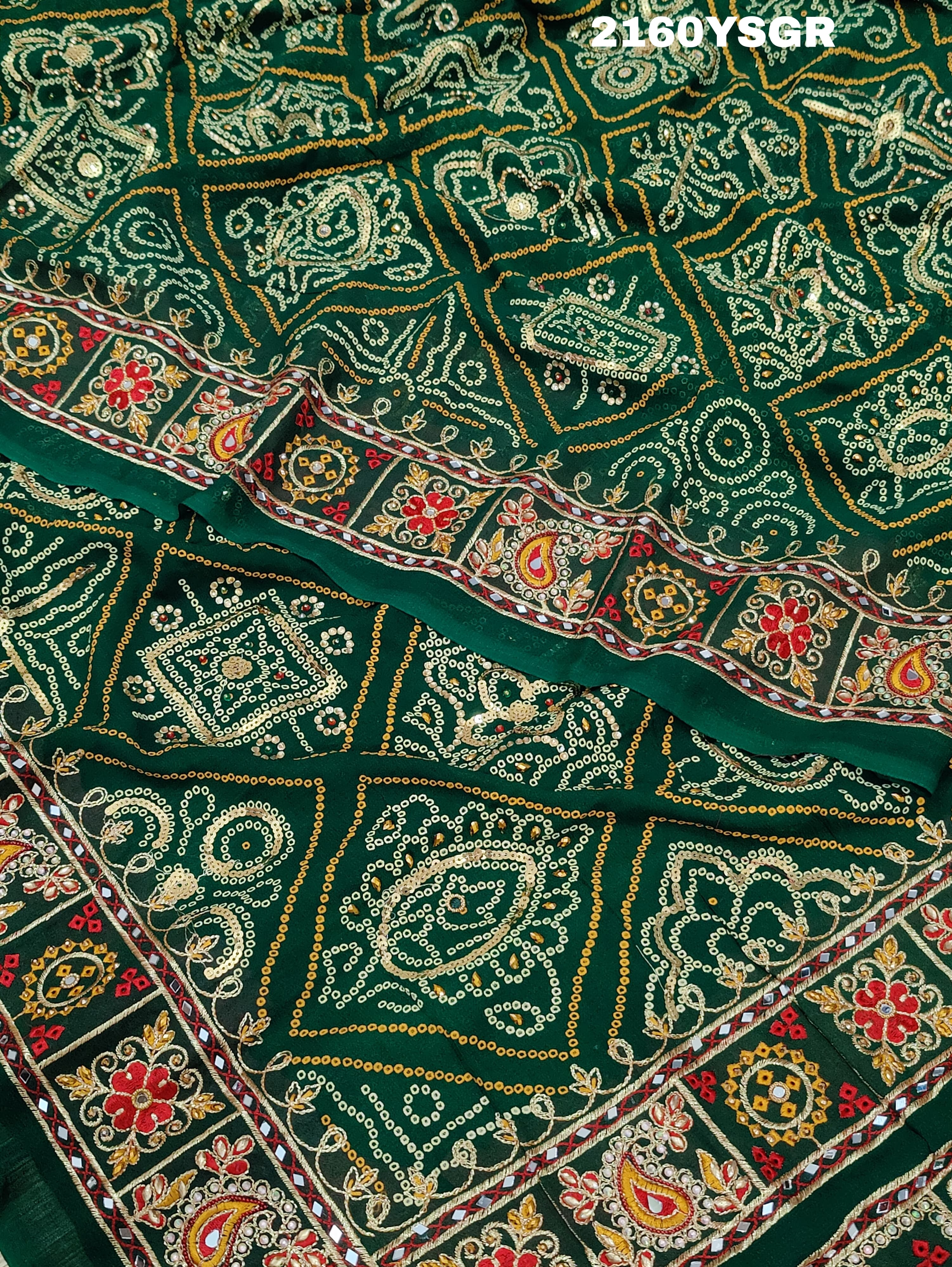 A green bandhej saree with royal aari and real mirror work, displayed on a surface.