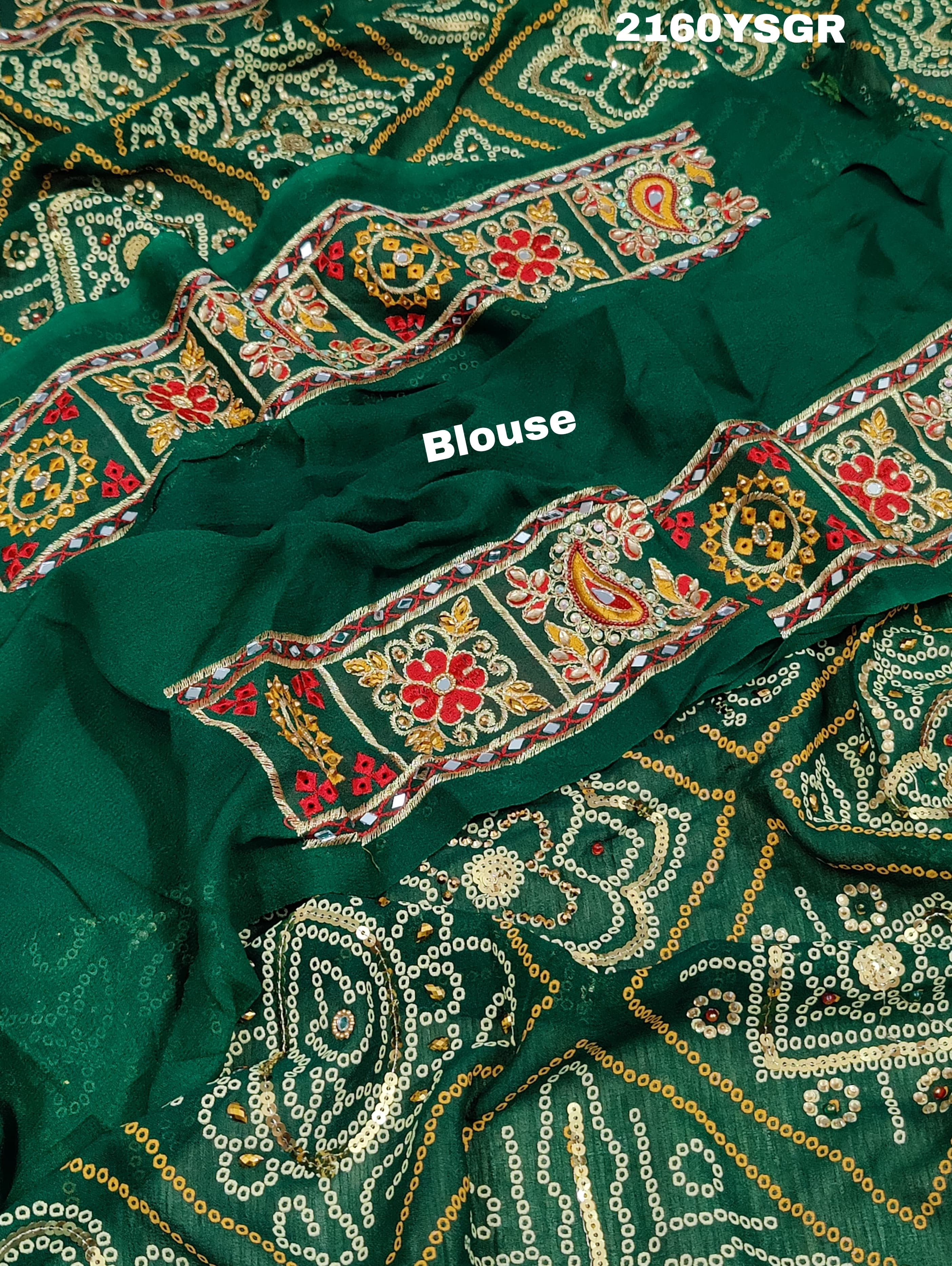 A green bandhej saree with royal aari and real mirror work, displayed on a surface.