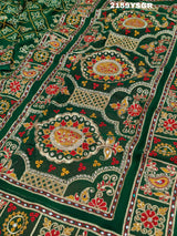 A green saree with traditional Jaipuri Rajwadi style embroidery and bandhani patterns, including real vintage mirror work.