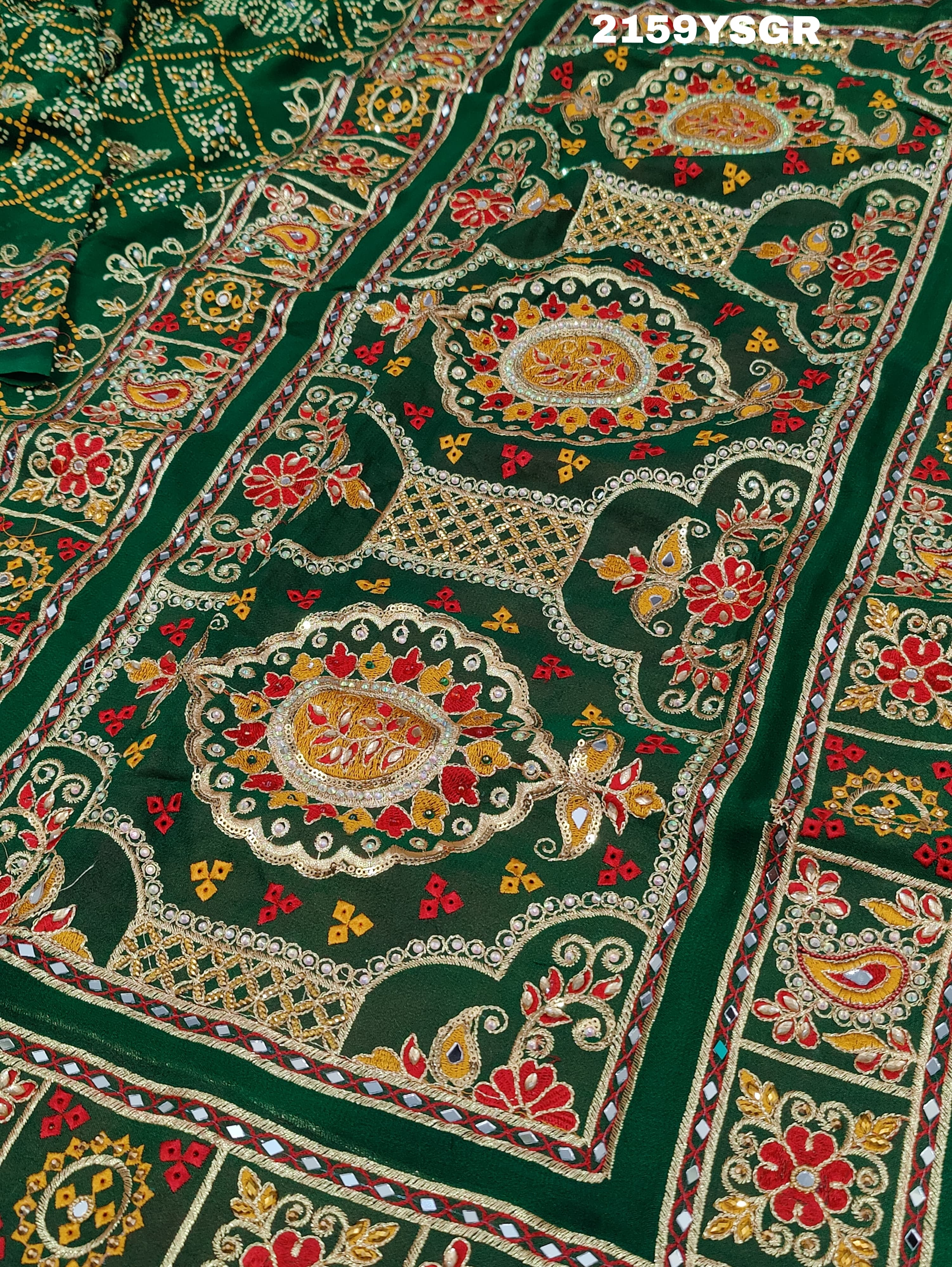 A green saree with traditional Jaipuri Rajwadi style embroidery and bandhani patterns, including real vintage mirror work.