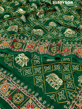 A green saree with traditional Jaipuri Rajwadi style embroidery and bandhani patterns, including real vintage mirror work.