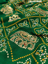 A green saree with traditional Jaipuri Rajwadi style embroidery and bandhani patterns, including real vintage mirror work.