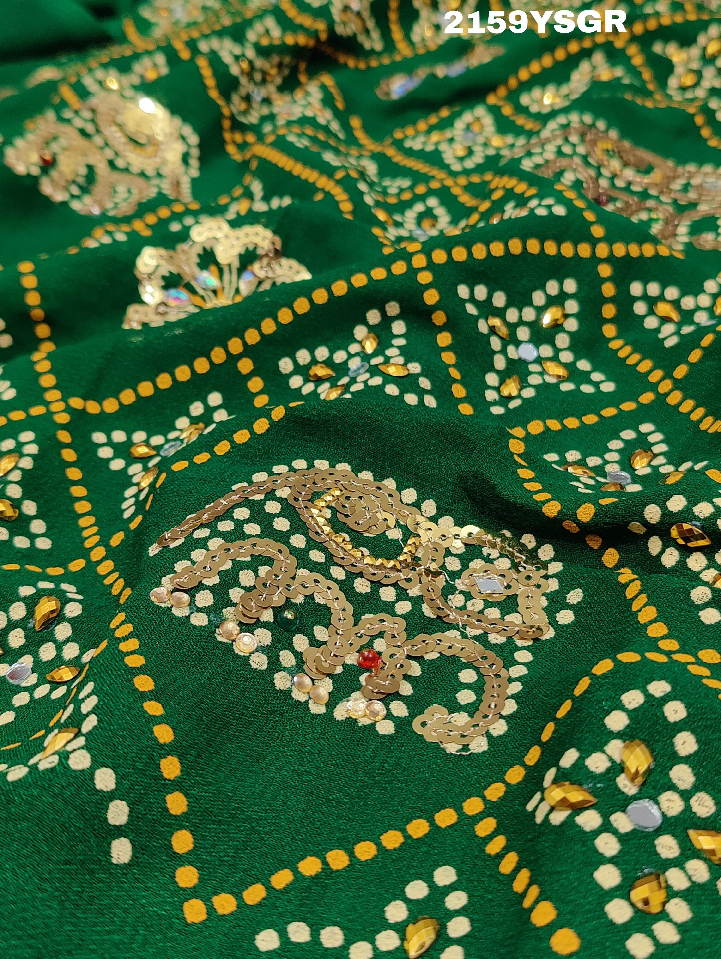 A green saree with traditional Jaipuri Rajwadi style embroidery and bandhani patterns, including real vintage mirror work.