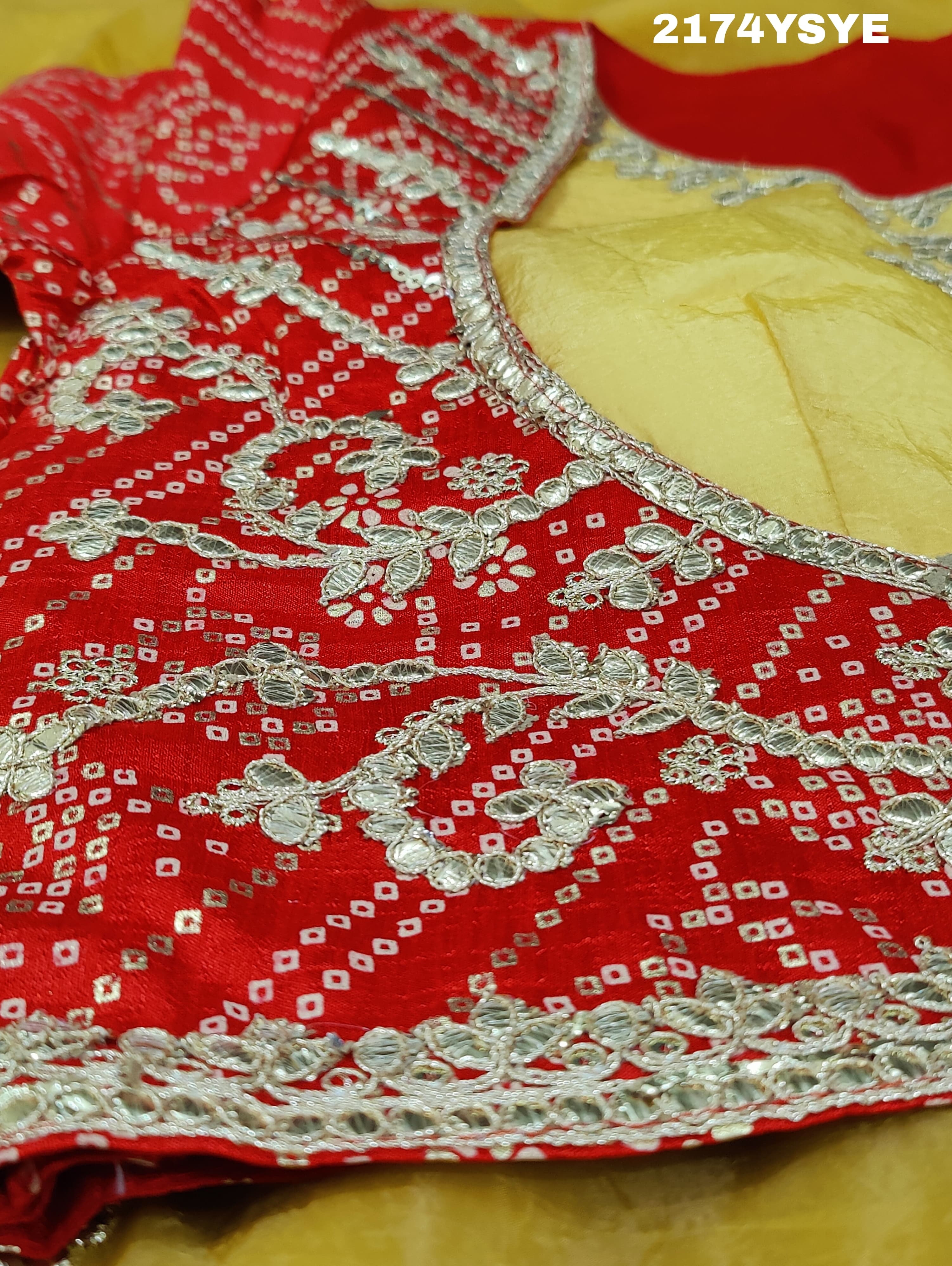 A yellow and red tissue silk saree with Bollywood style embellishments and gotapatti work.