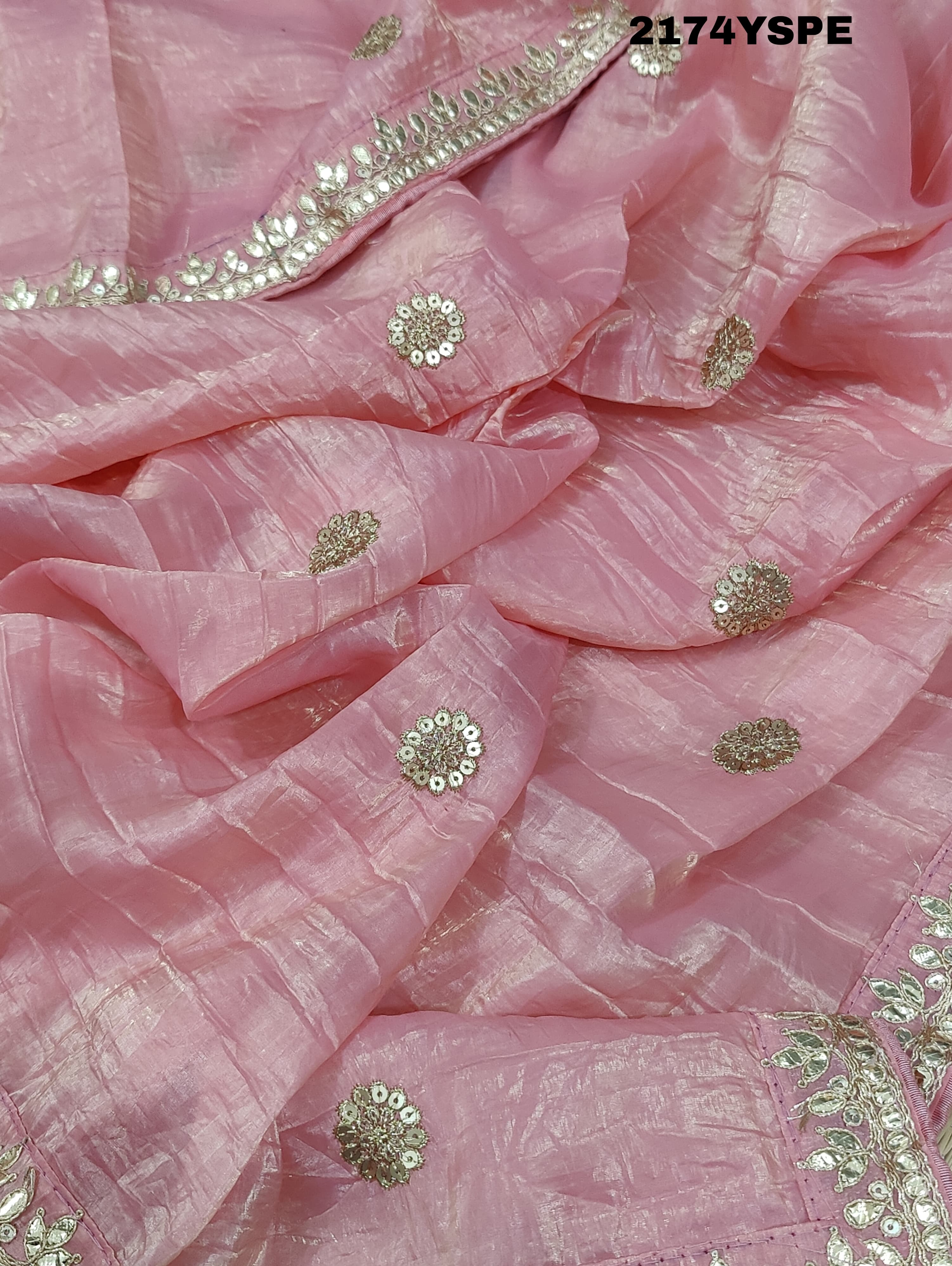 A saree with tissue silk fabric featuring Bollywood style embellishments and gotapatti work in red and pink colour
