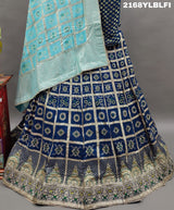 A traditional Indian lehenga with a blue and silver silk base and detailed cutdana work