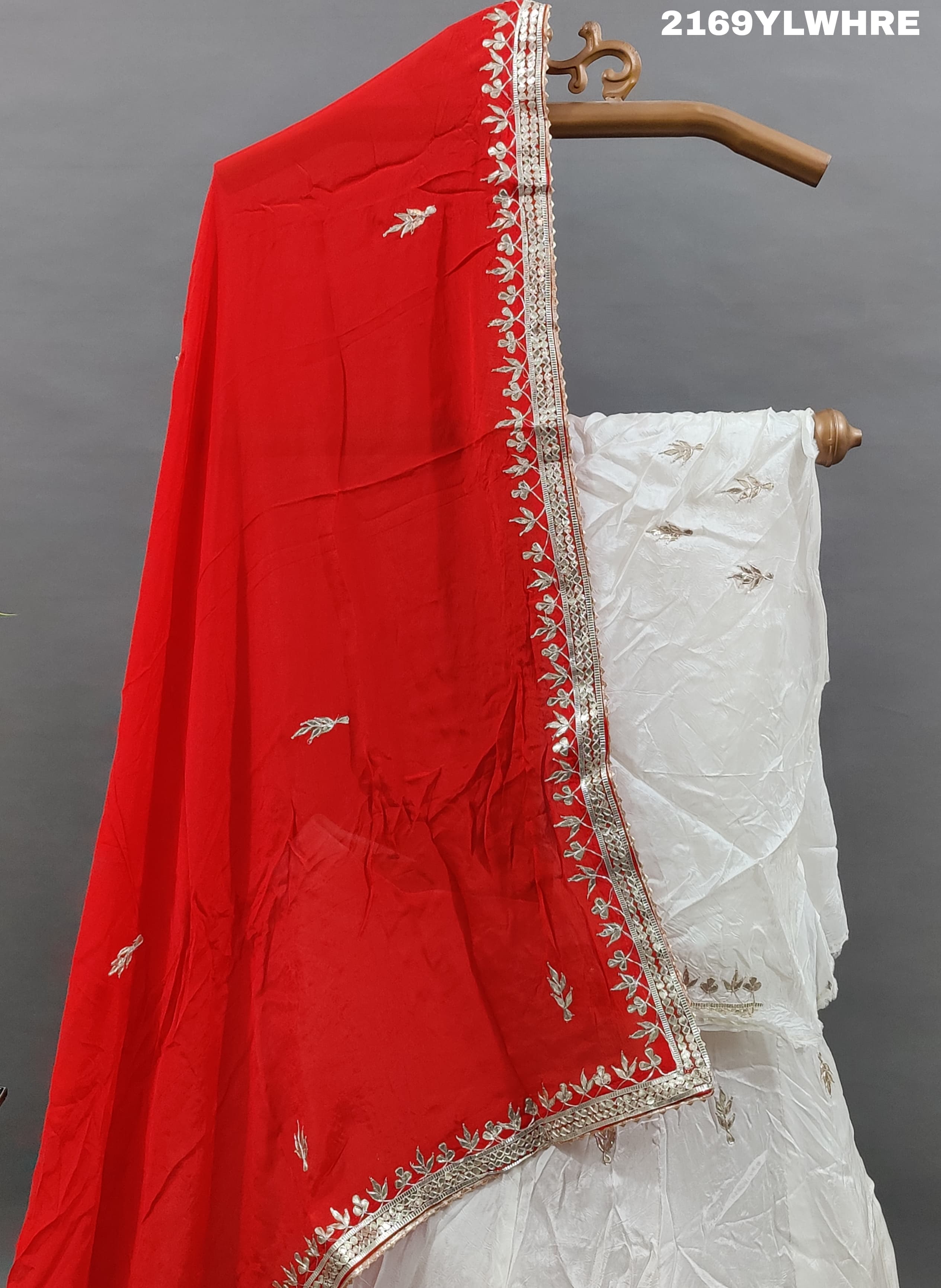 A traditional wear lehenga in white with gotapatti work
