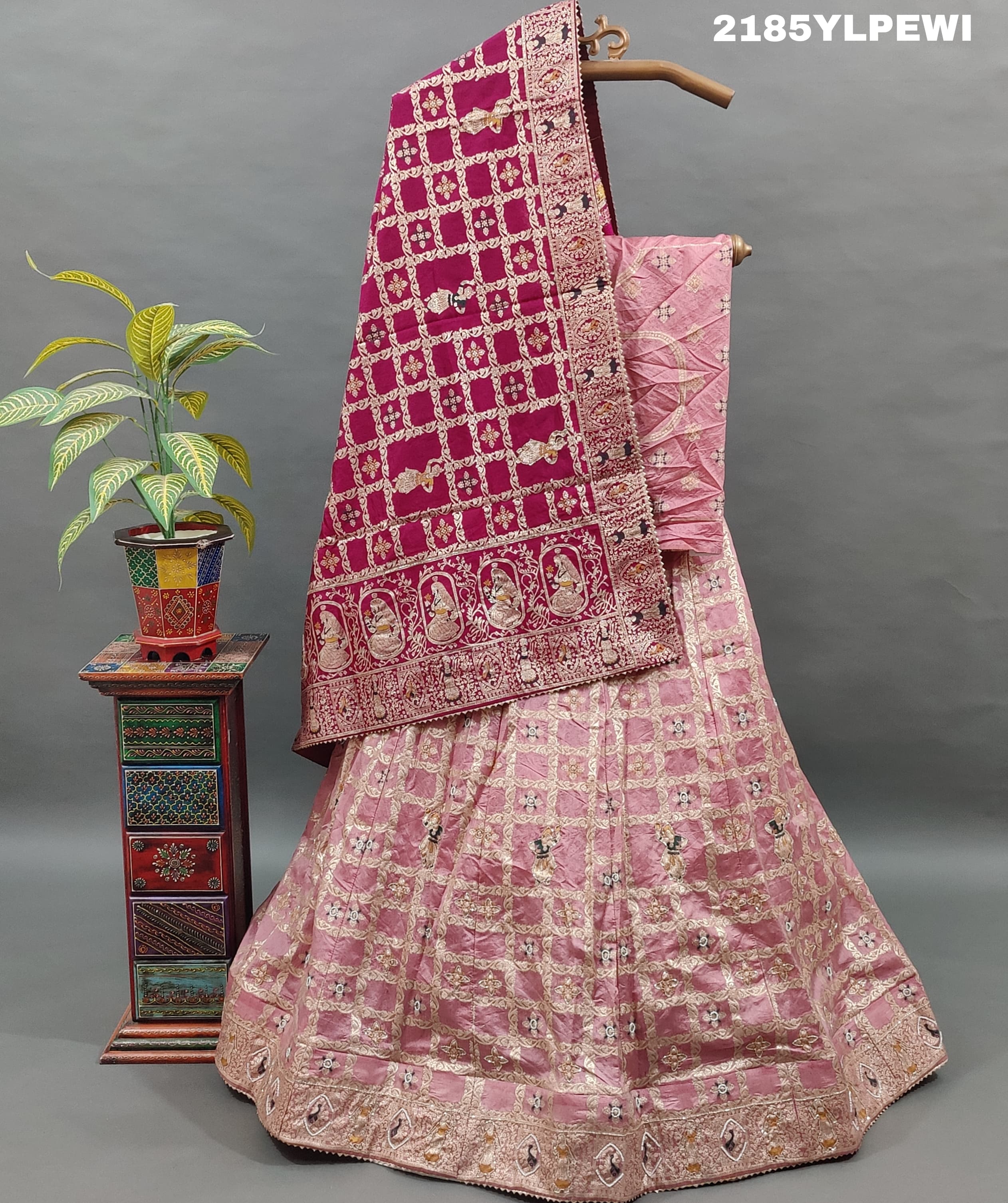 A Lehenga with Banarasi style pattern and white bead work in a traditional design.