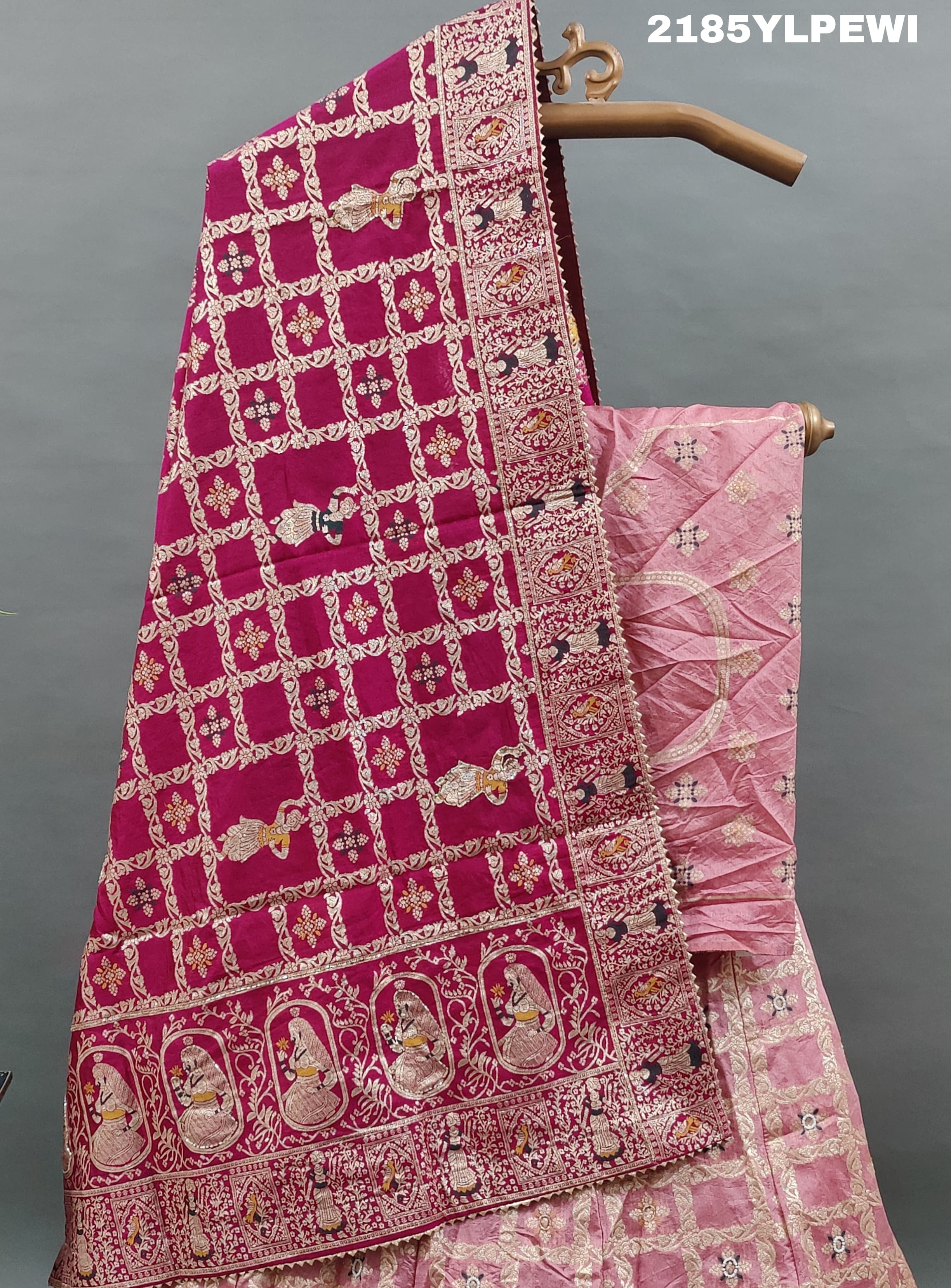 A Lehenga with Banarasi style pattern and white bead work in a traditional design.
