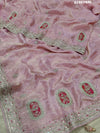 A pink tissue silk saree with traditional sequence Gotapatti work.
