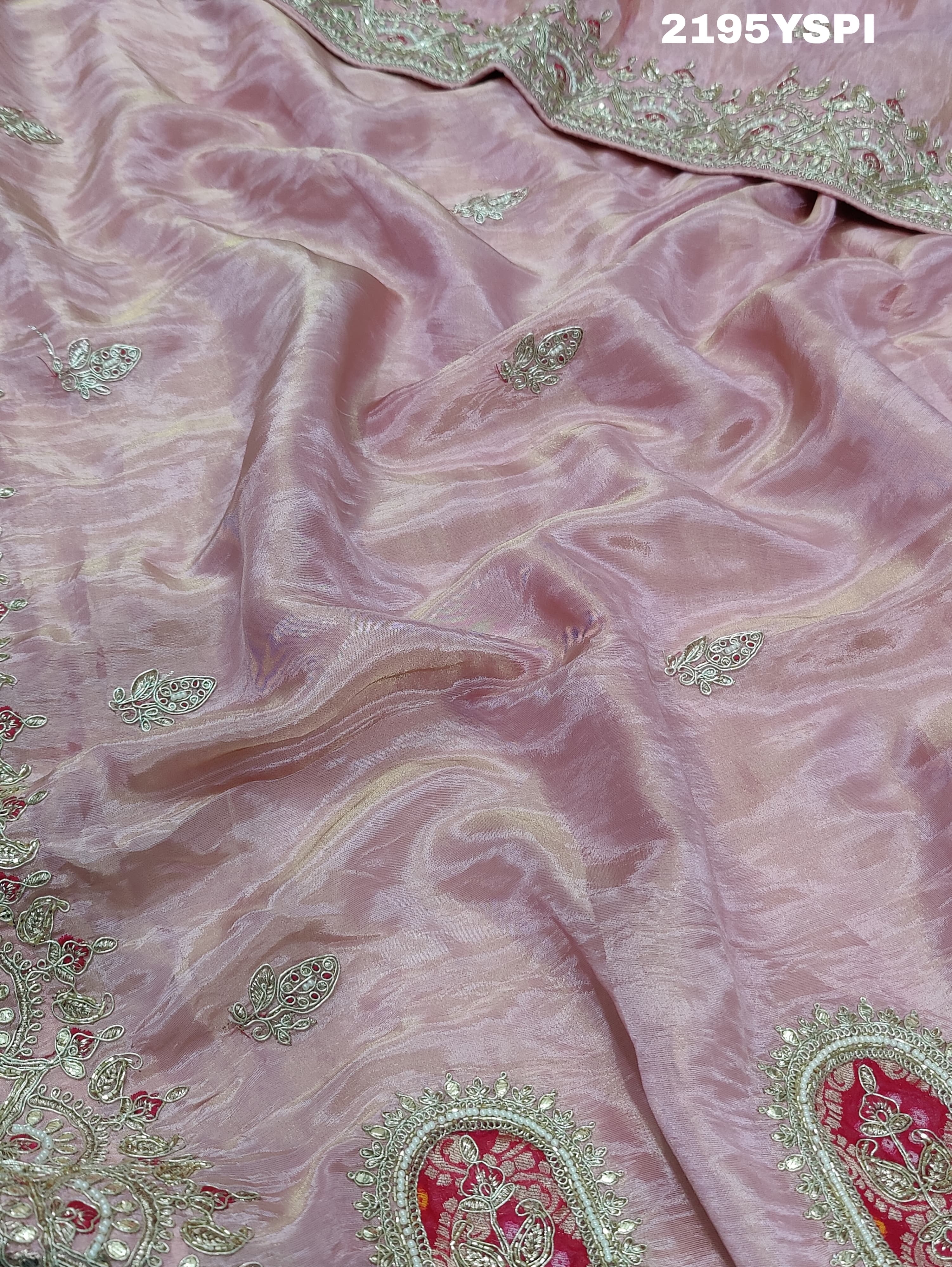 A pink tissue silk saree with traditional sequence Gotapatti work.