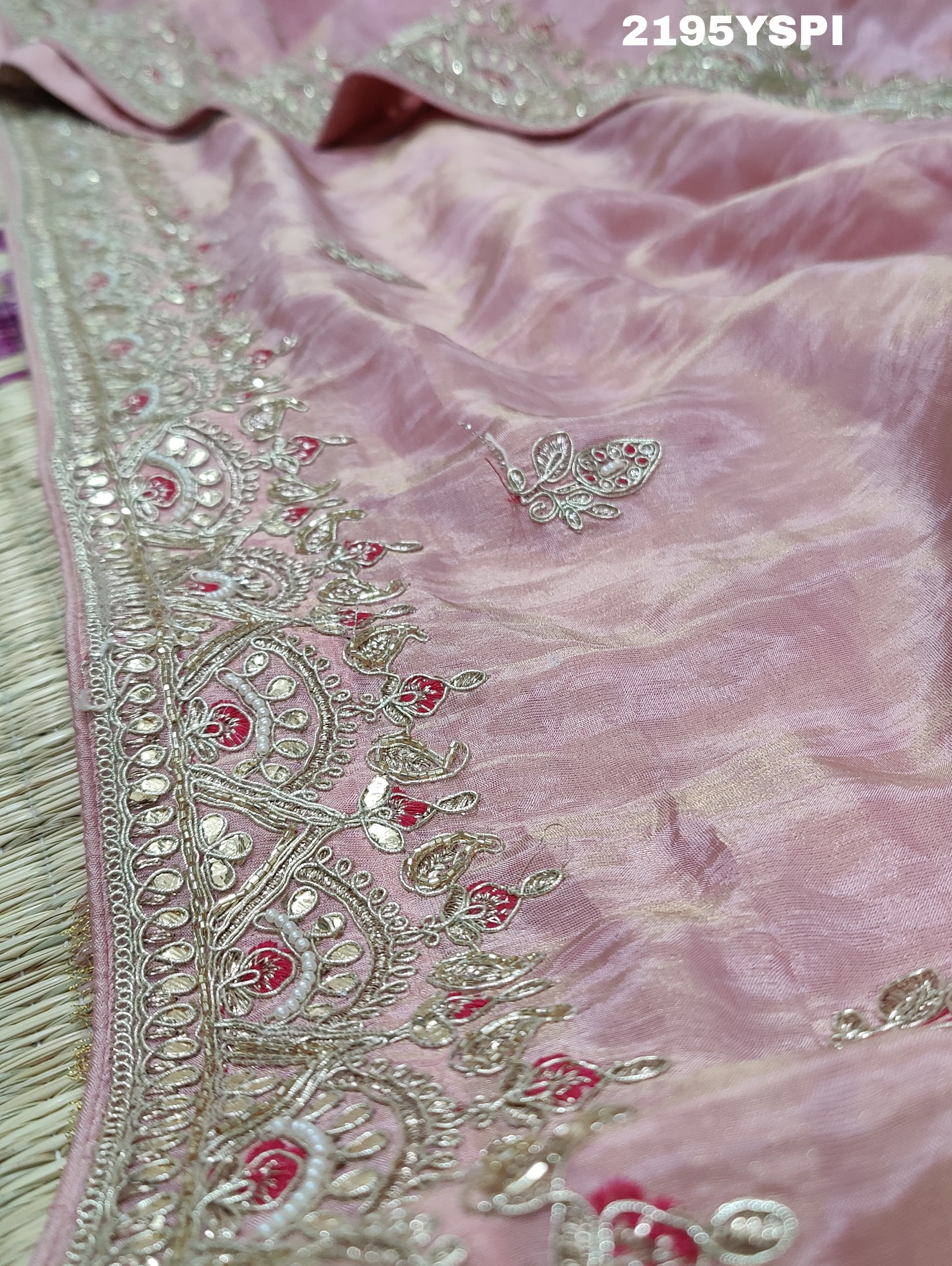 A pink tissue silk saree with traditional sequence Gotapatti work.