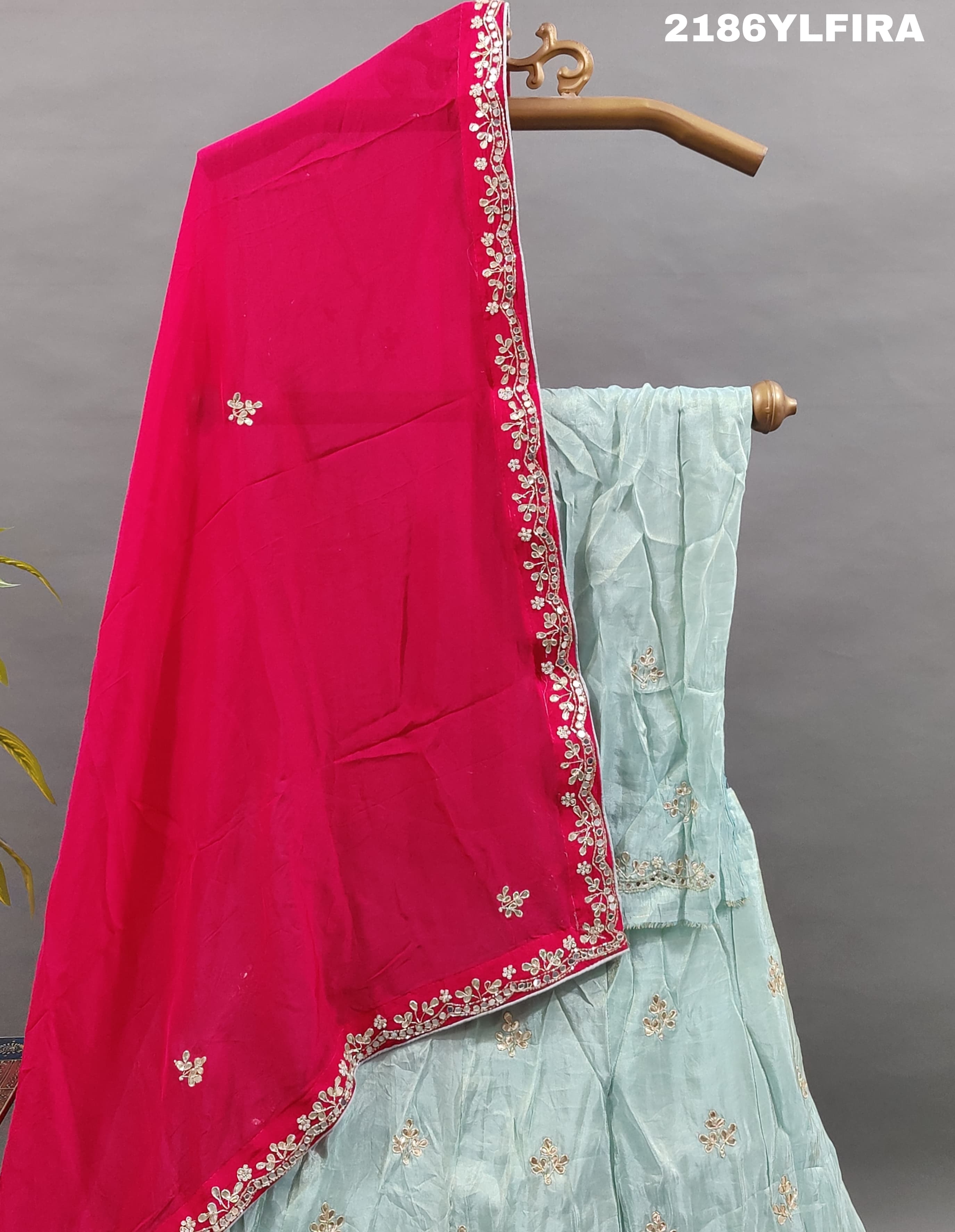 A Bollywood style blue Lehenga with pink embellishments and a red dupatta.