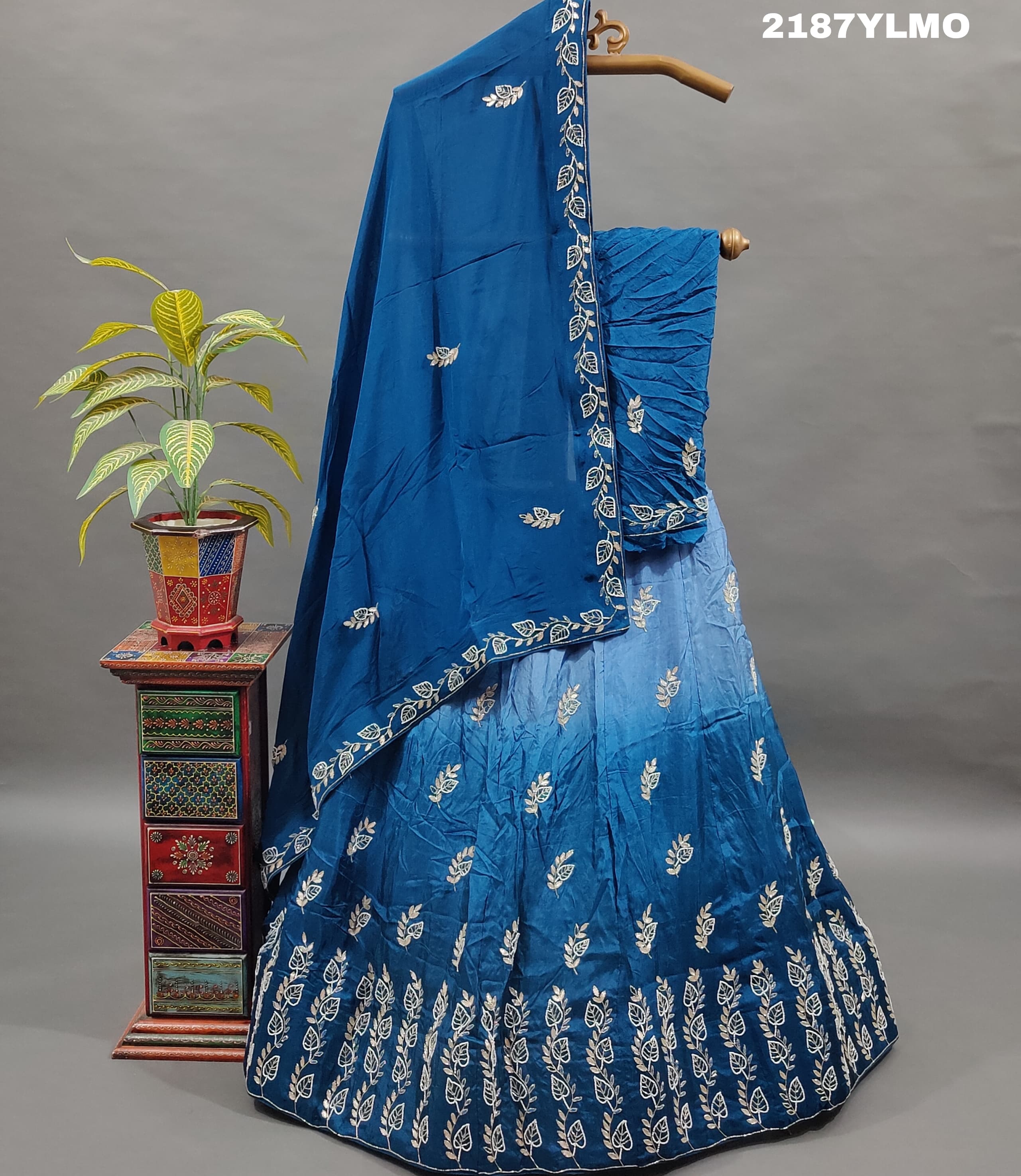 A blue traditional style silk lehenga with white bead work