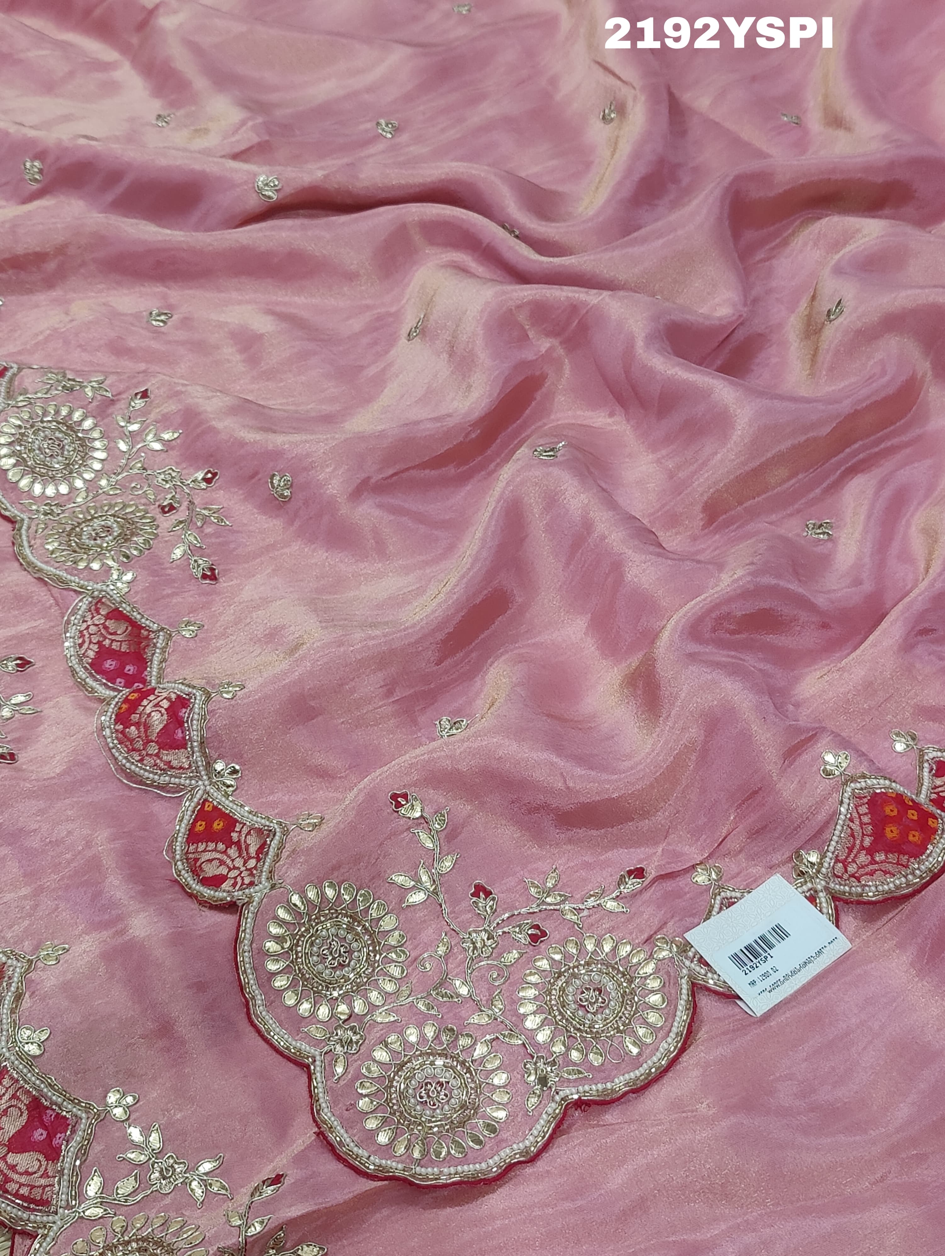 A pink Chinon silk saree with white and silver cutdana bead work and traditional border design.