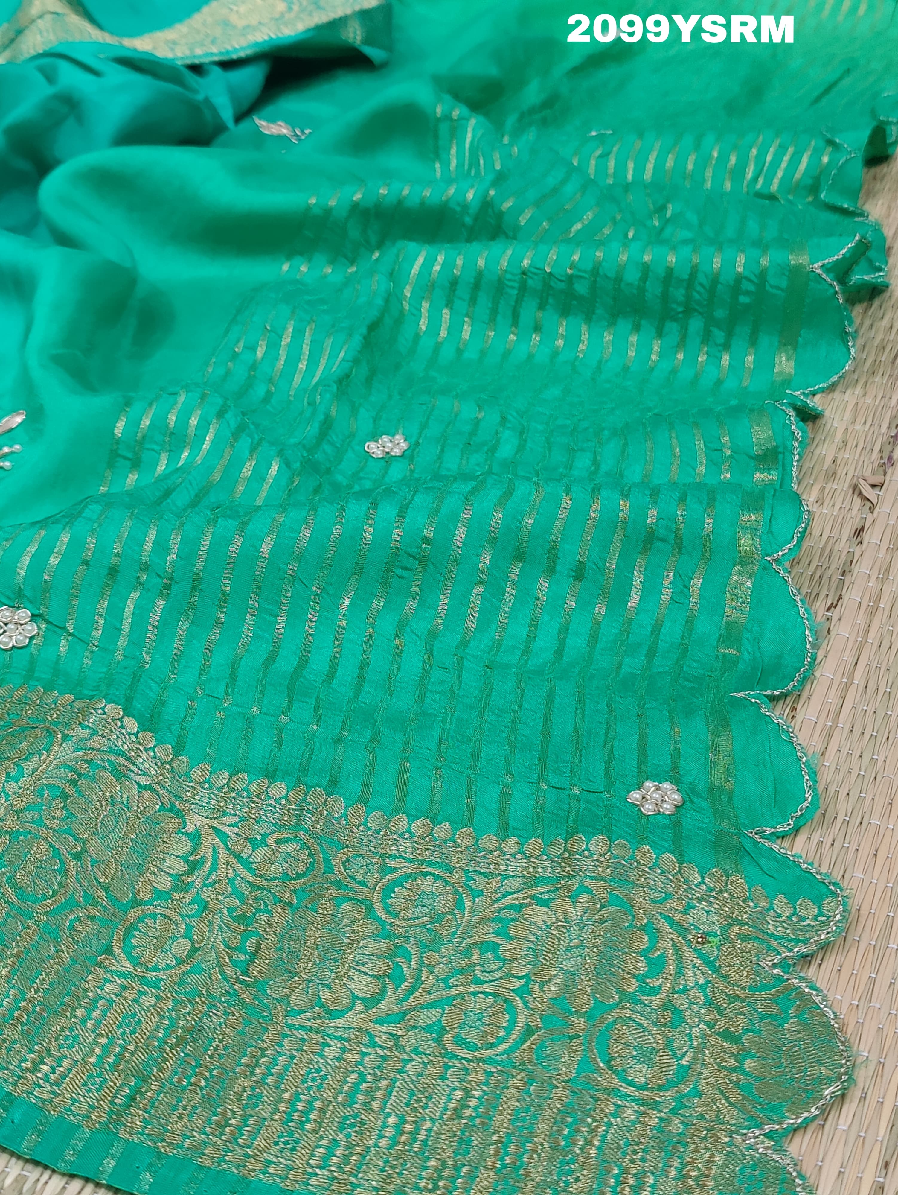 A green saree with floral zardozi work and Banarasi style