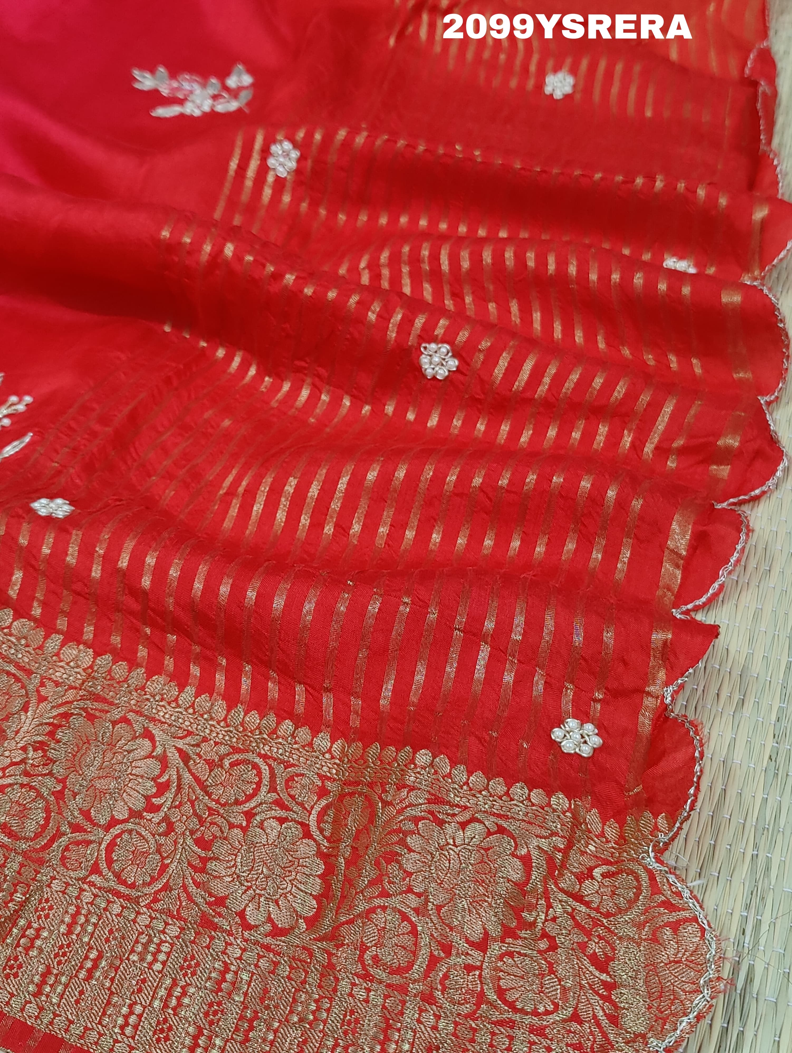 A red and gold Banarasi style silk saree with zardozi work,