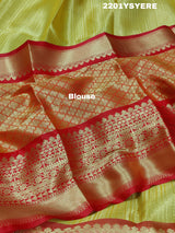 A Banarasi style saree in yellow and red with a tissue silk pattern, suitable for festival wear.
