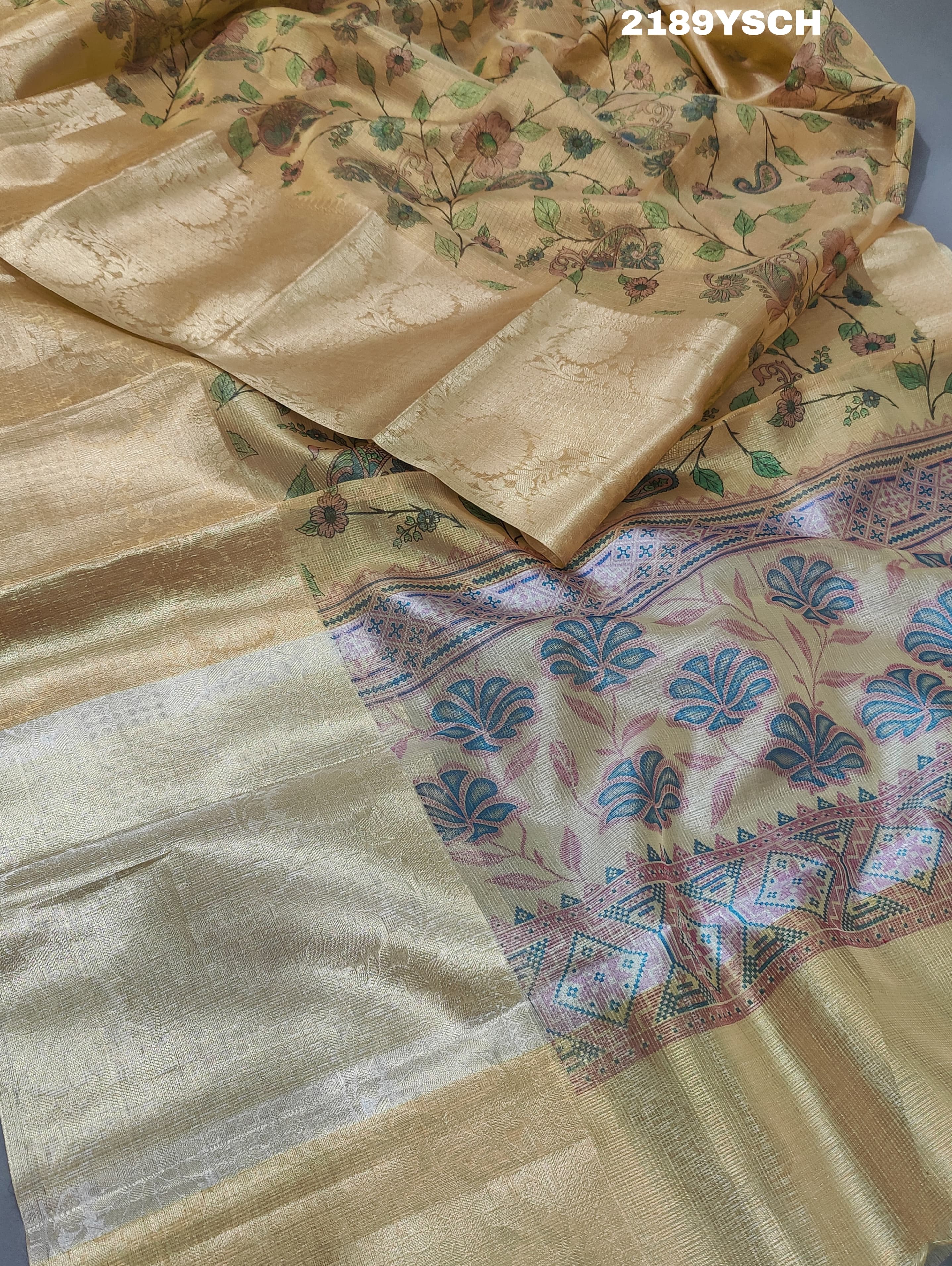 A yellow and blue floral patterned Tussar silk saree with Banarasi weaving.