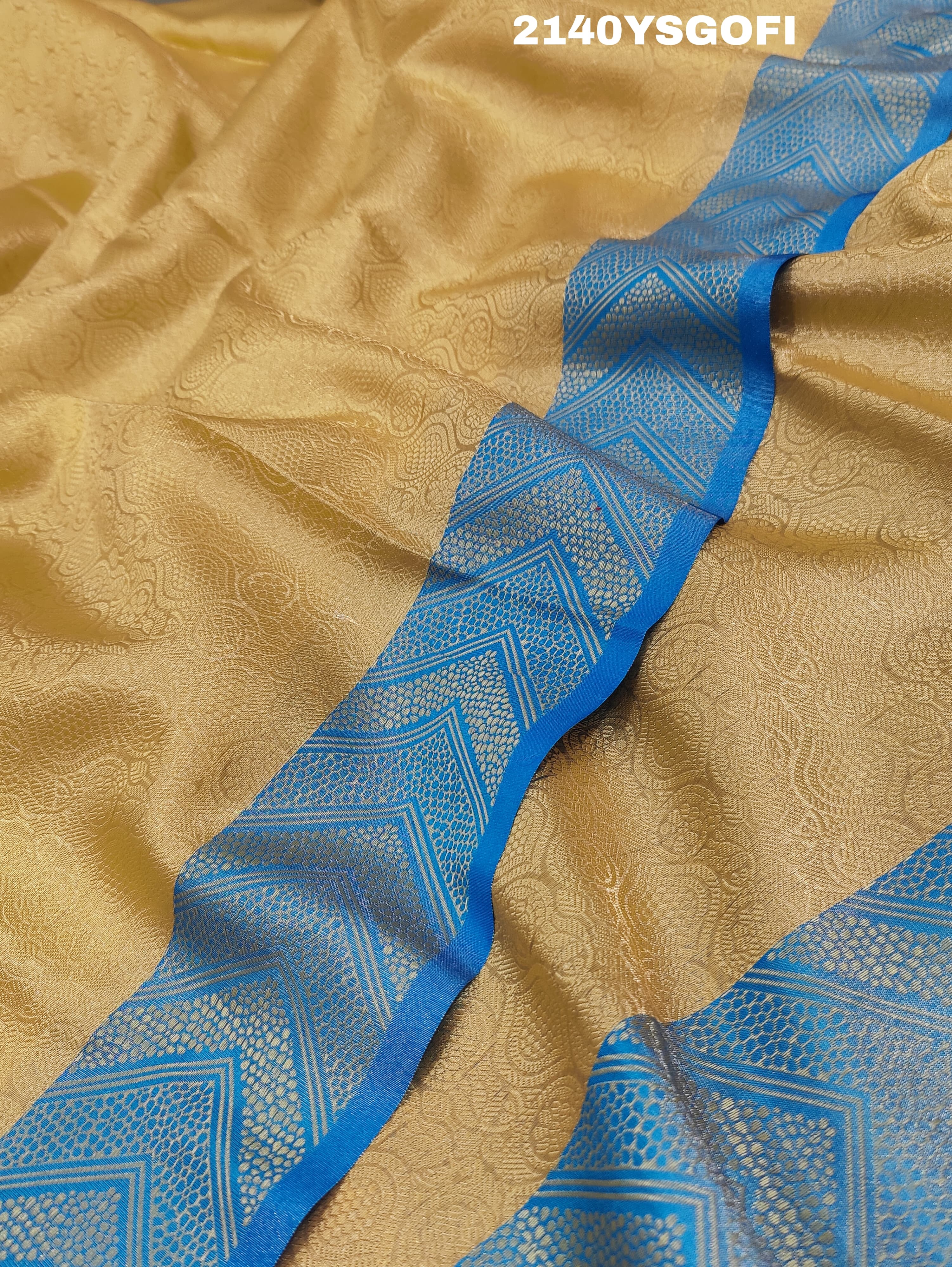 A tissue silk banarasi saree with zari weaving, featuring a blue and gold design on a beige fabric, meant for party or casual wear.