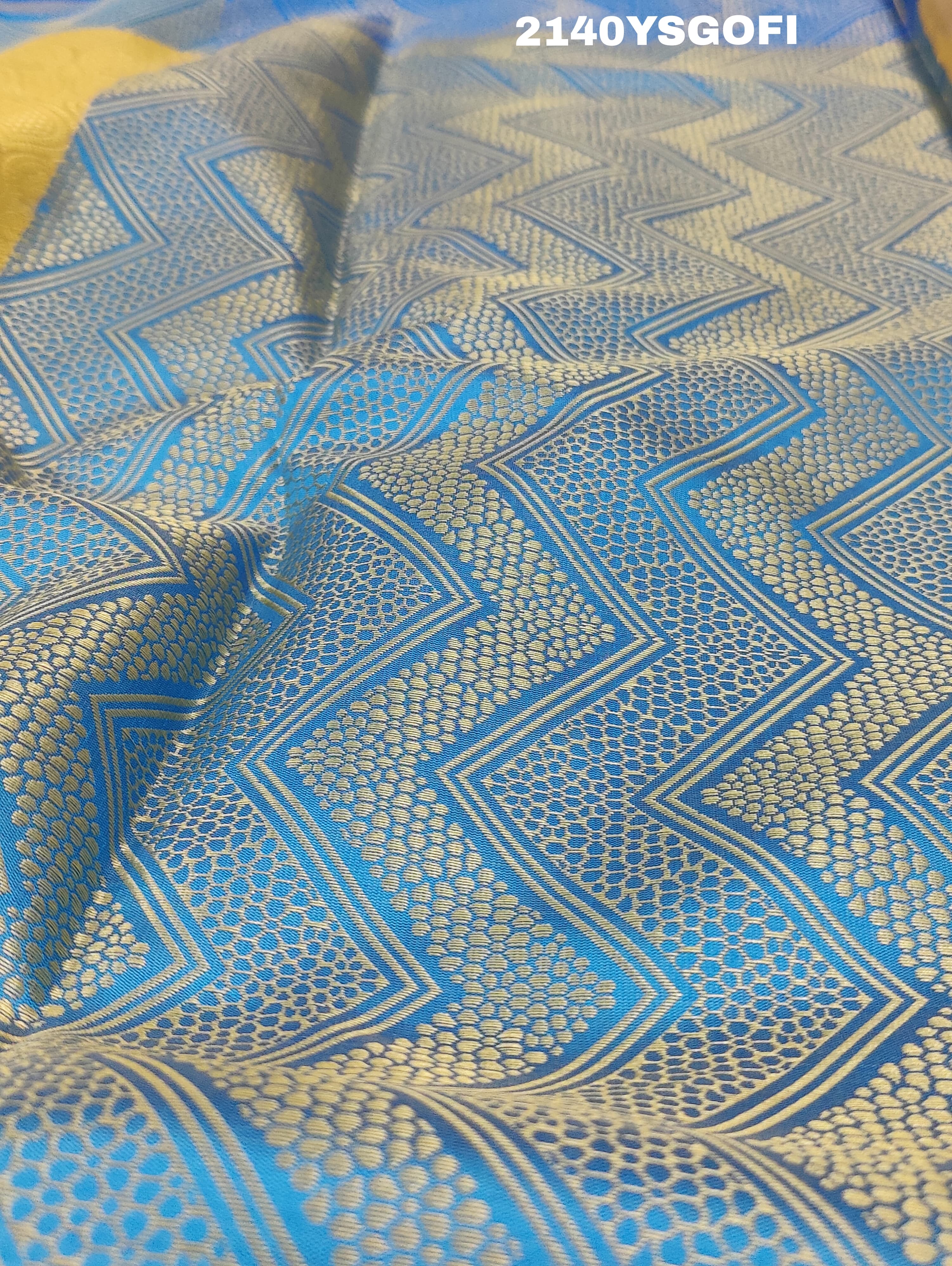 A tissue silk banarasi saree with zari weaving, featuring a blue and gold design on a beige fabric, meant for party or casual wear.