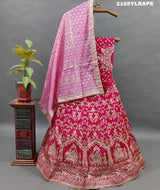 A traditional Indian lehenga choli in pink and white Banarasi silk handwork