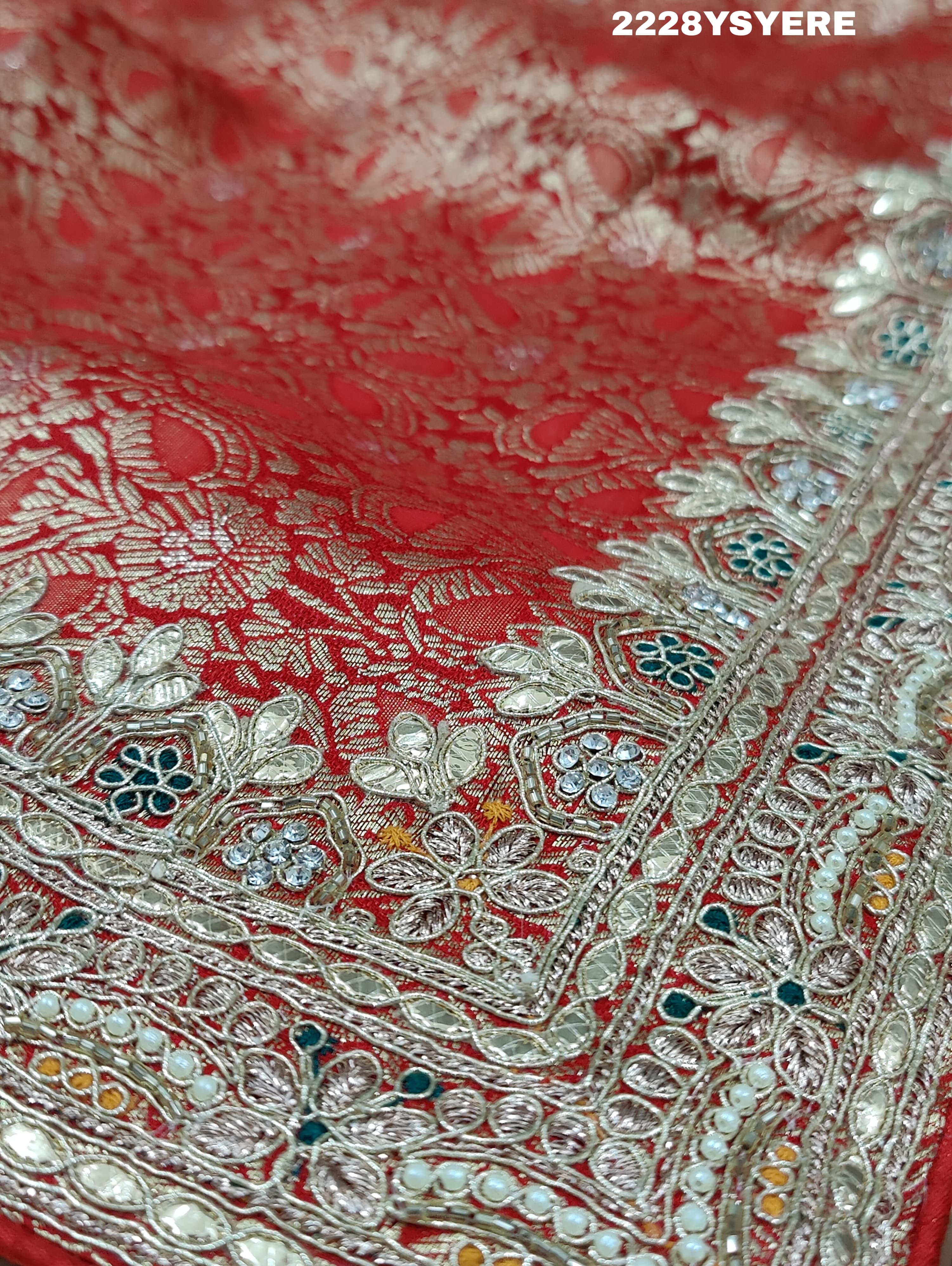 A yellow and red traditional saree with sequence embroidery work and a Banarasi style border.