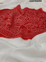 A traditional saree with red and white colors and intricate patterns, predominantly red at one end with a floral design.