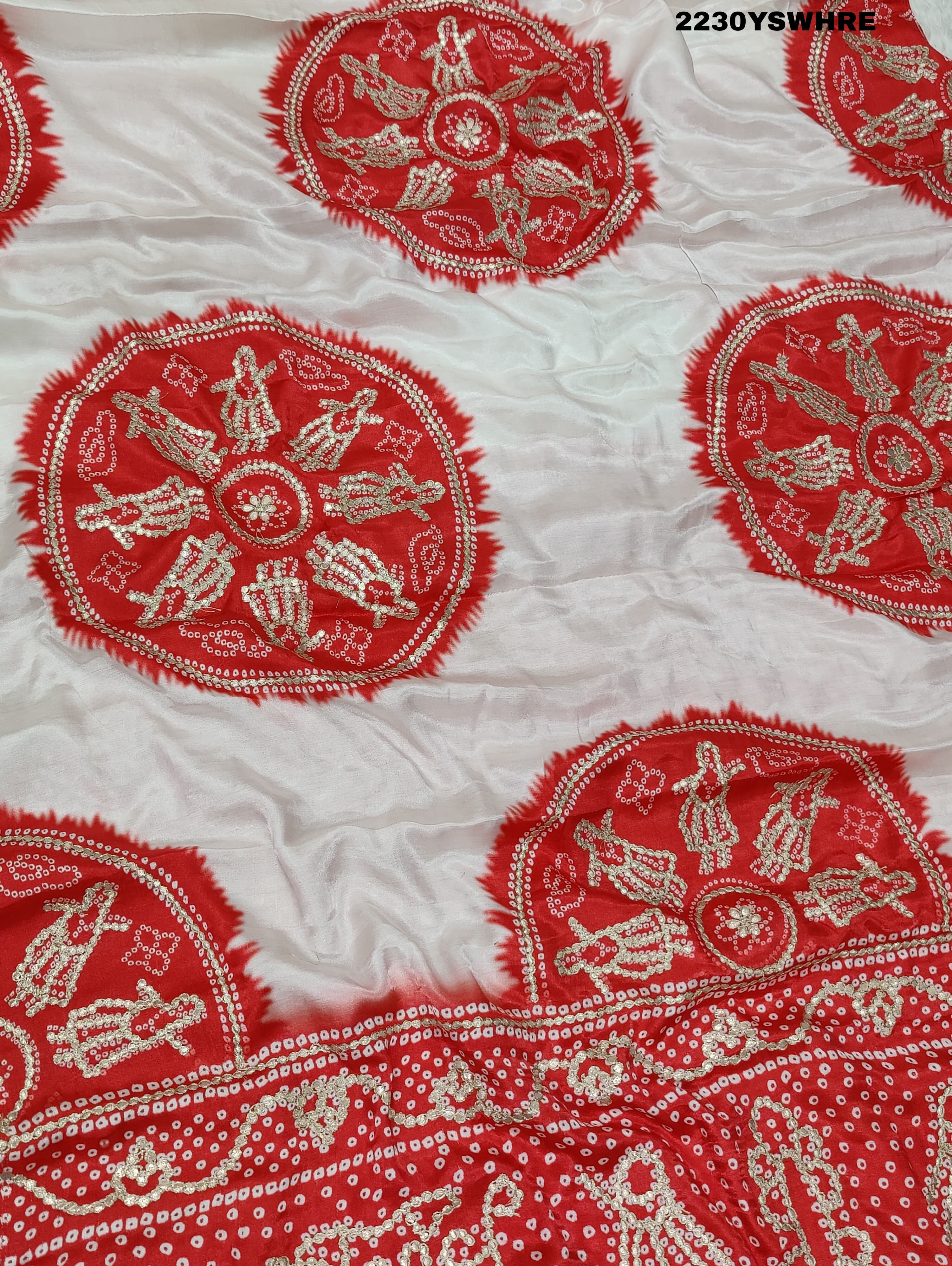 A red and white bandhani style saree with gotapatti work