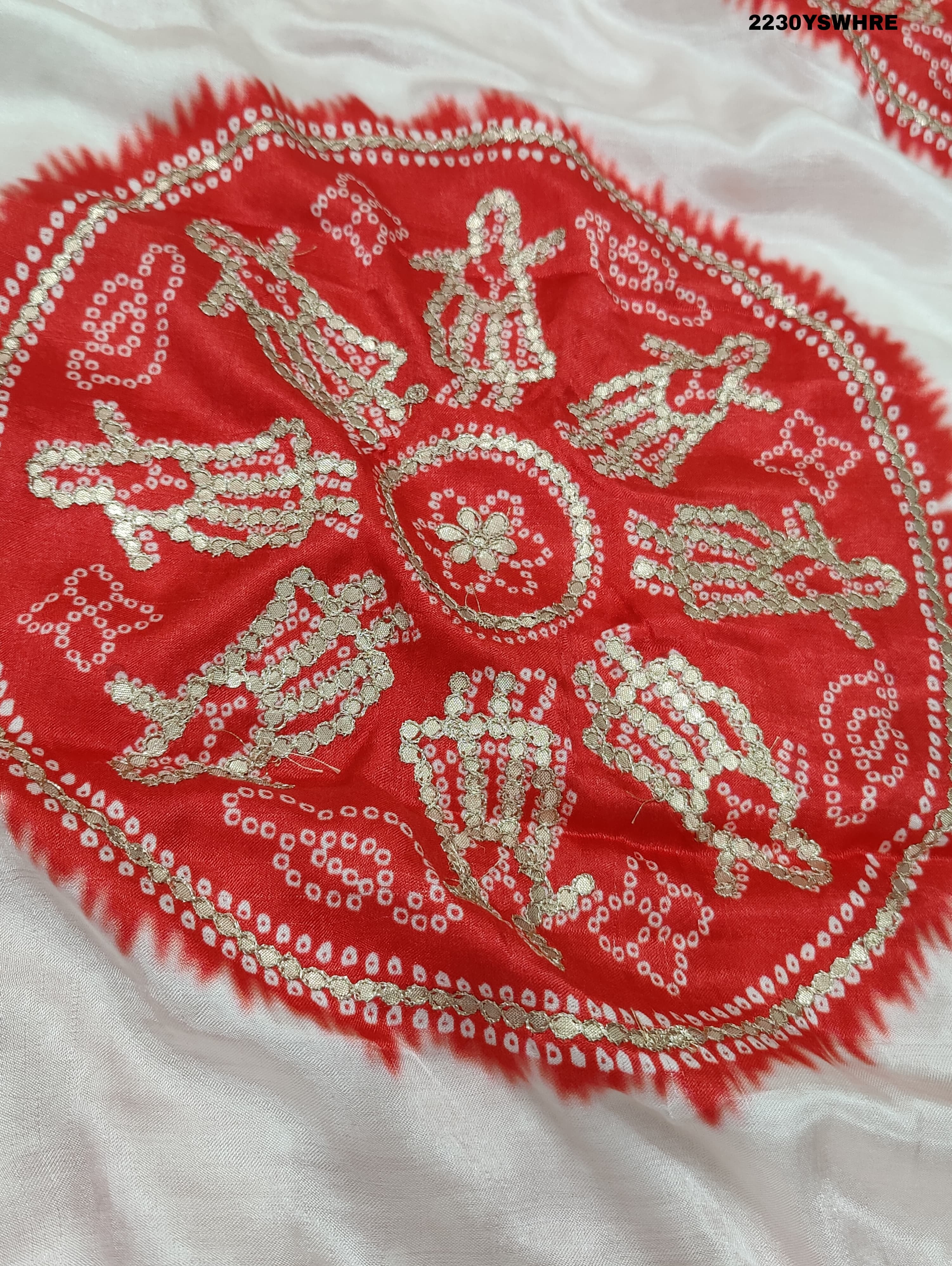A red and white bandhani style saree with gotapatti work