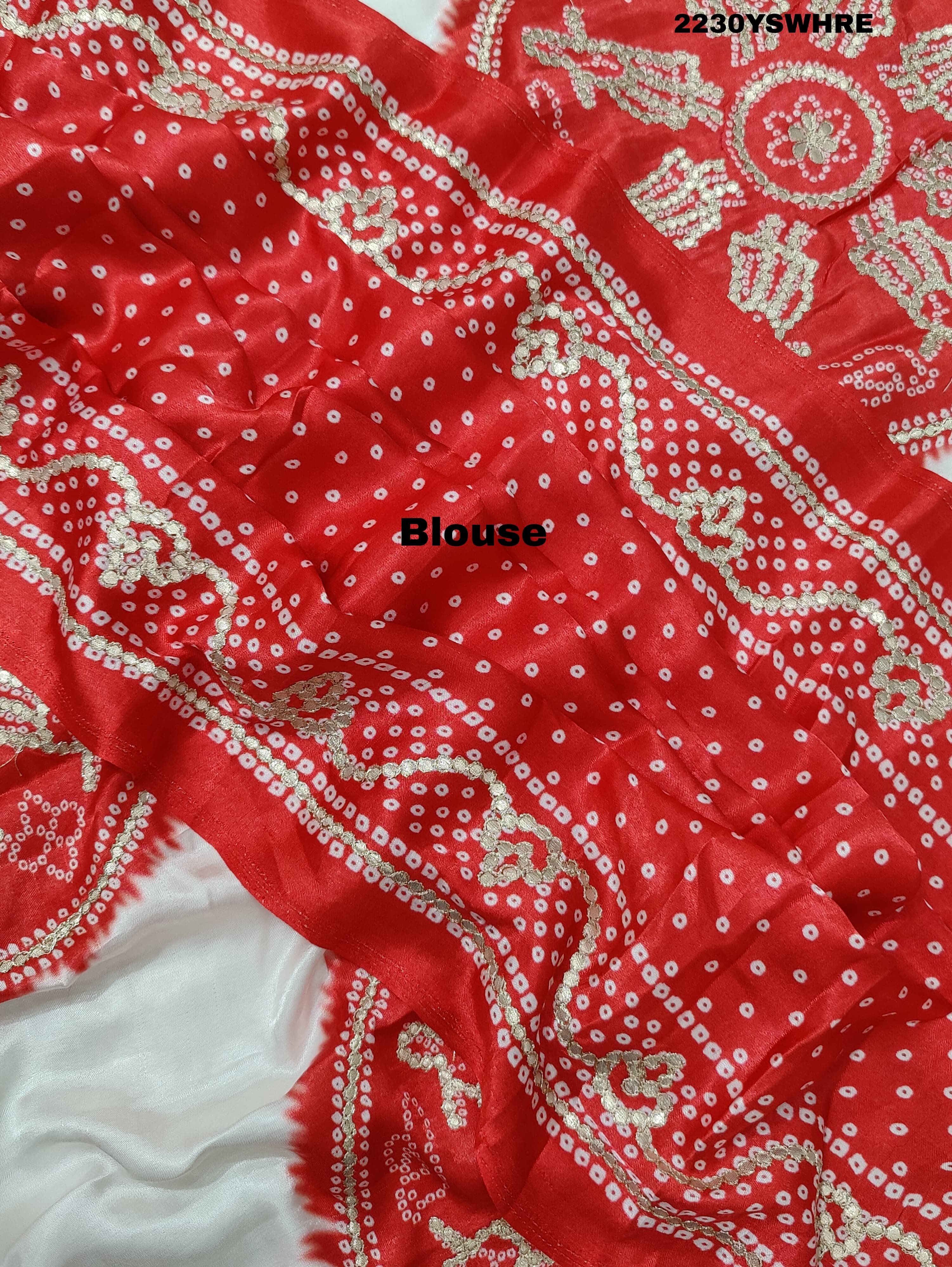 A red and white bandhani style saree with gotapatti work