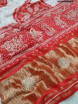 A red and white bandhani style saree with gotapatti work