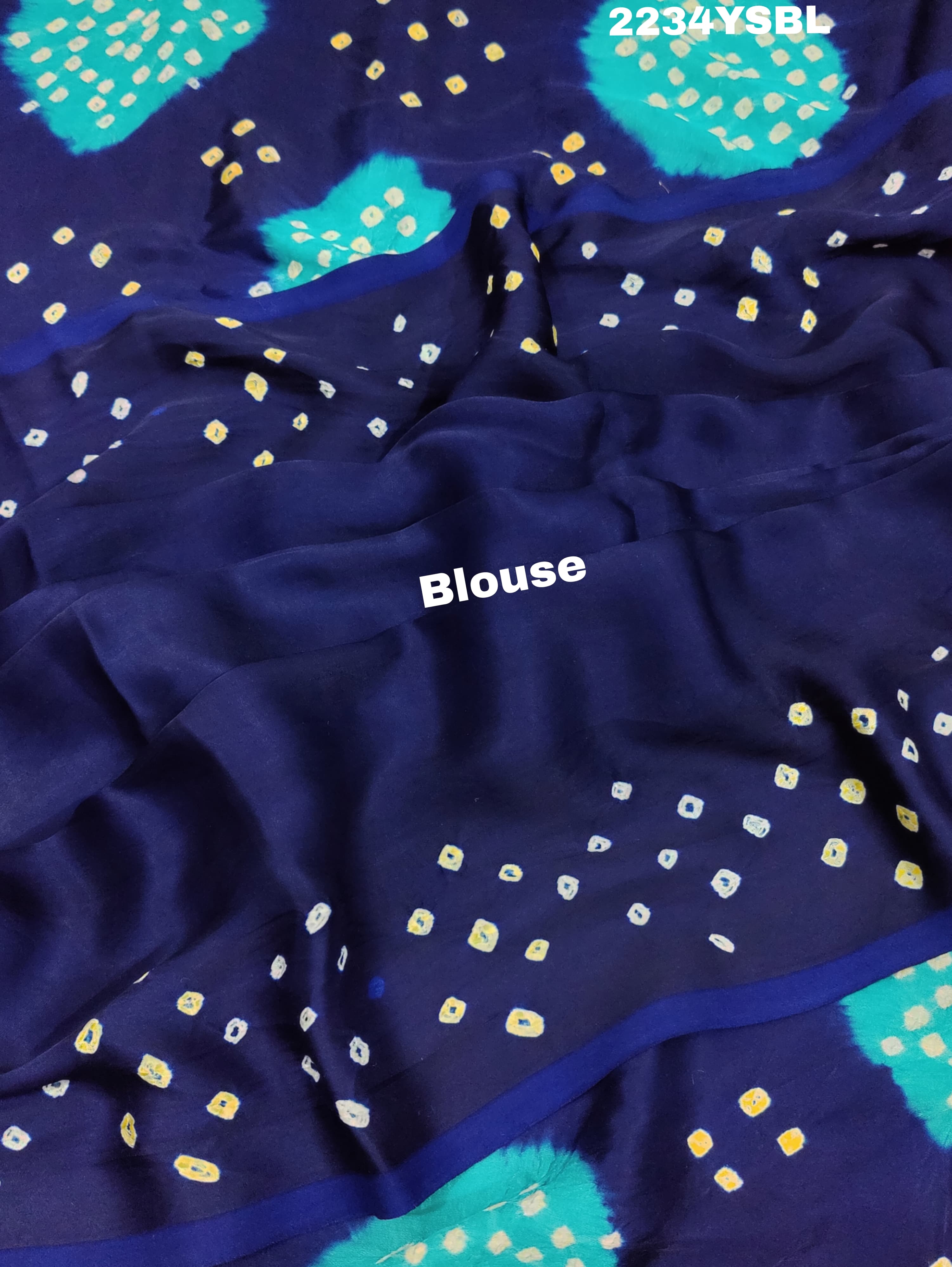 A blue and green bandhani style saree with a floral pattern