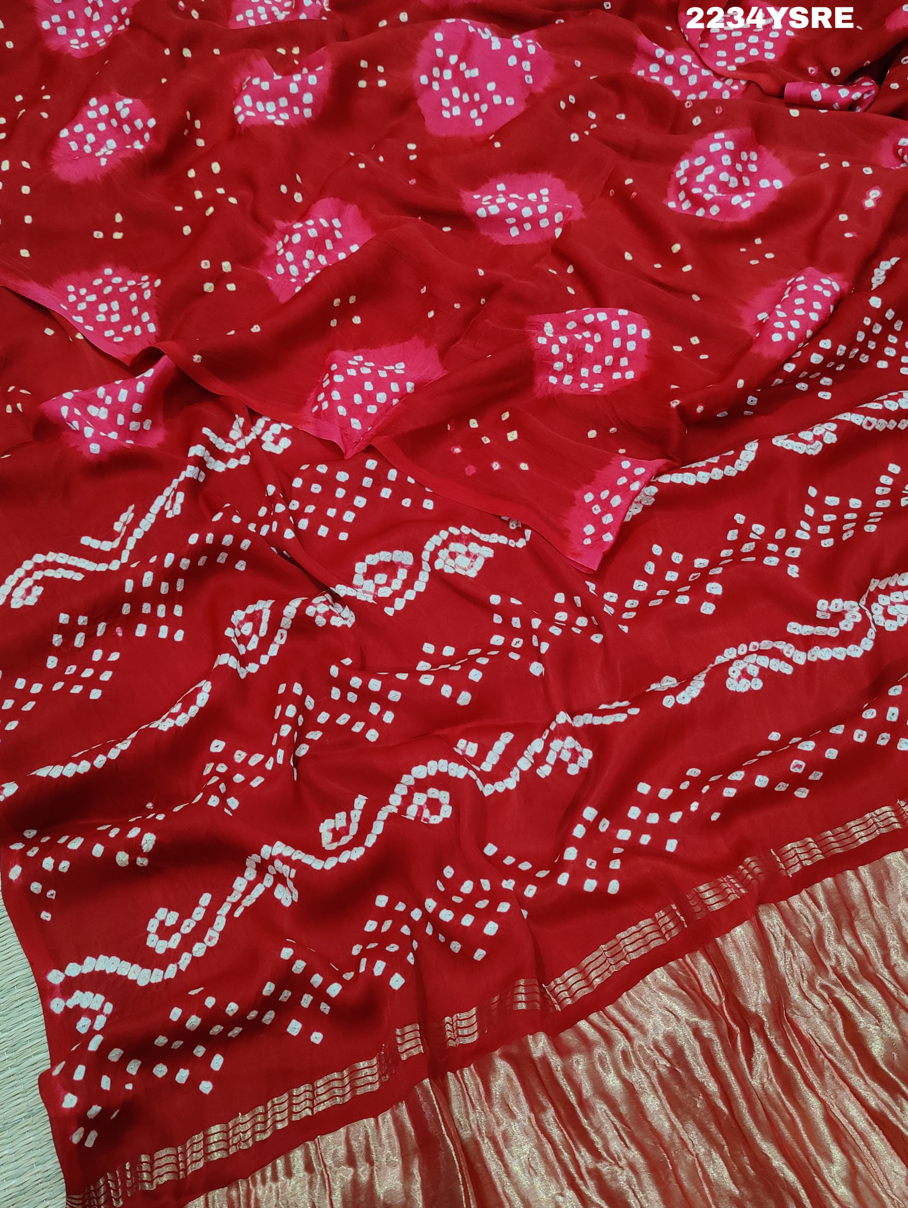 A red and white bandhani style saree