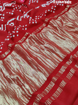 A red and white bandhani style saree